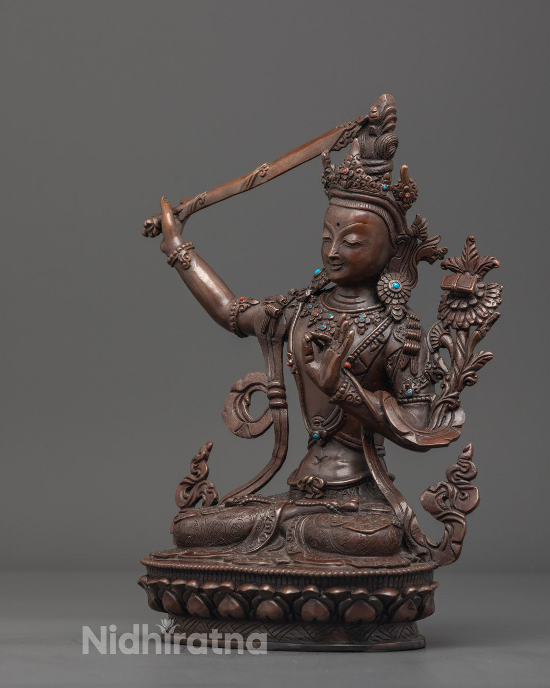 Spiritual Buddhist deity Manjushri statue in oxidized copper, richly adorned and perfect for meditation and home altar decor