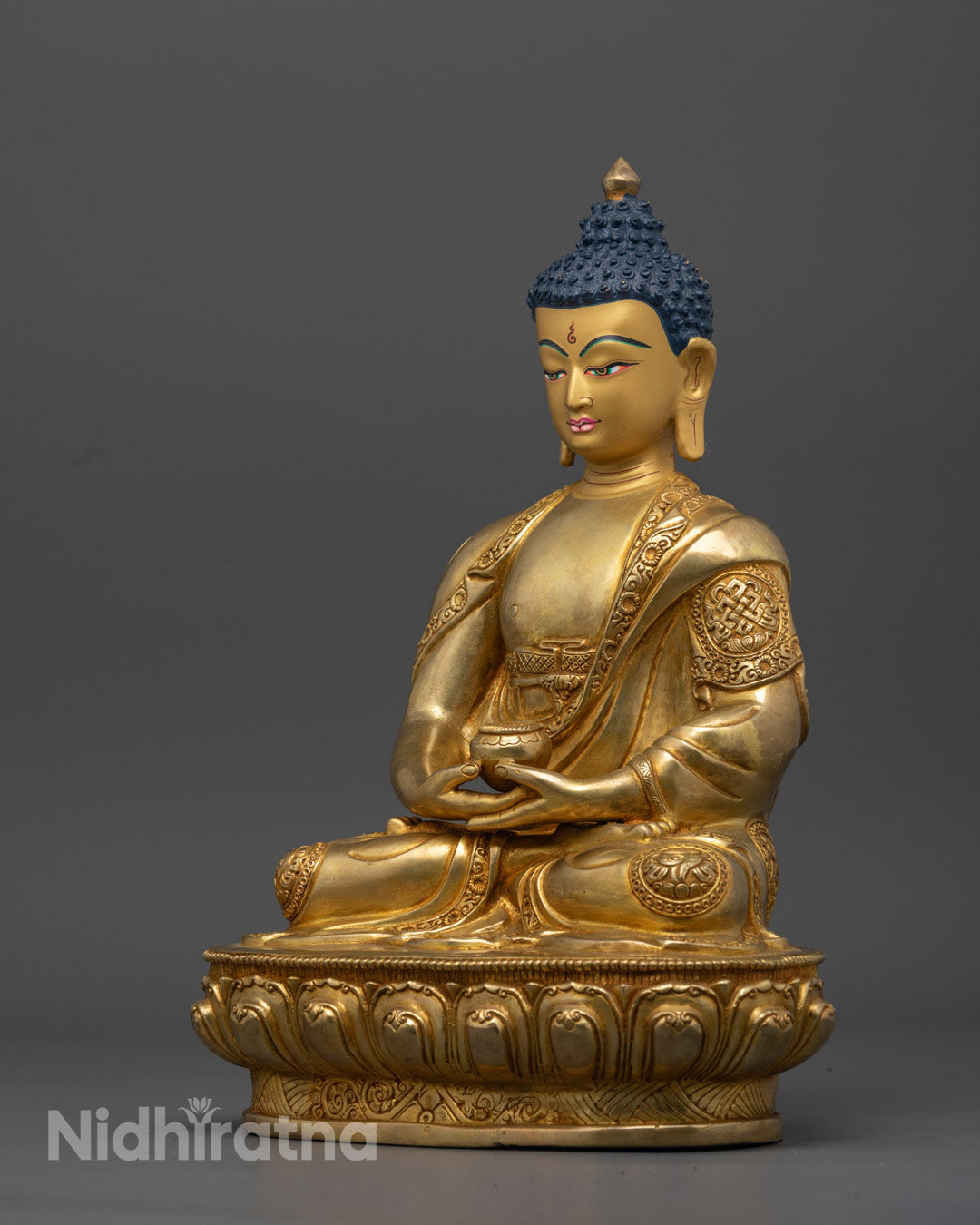 The 24K gold-gilded Amitabha Buddha statue's serene face, radiating compassion and wisdom, with intricate facial features and peaceful expression
