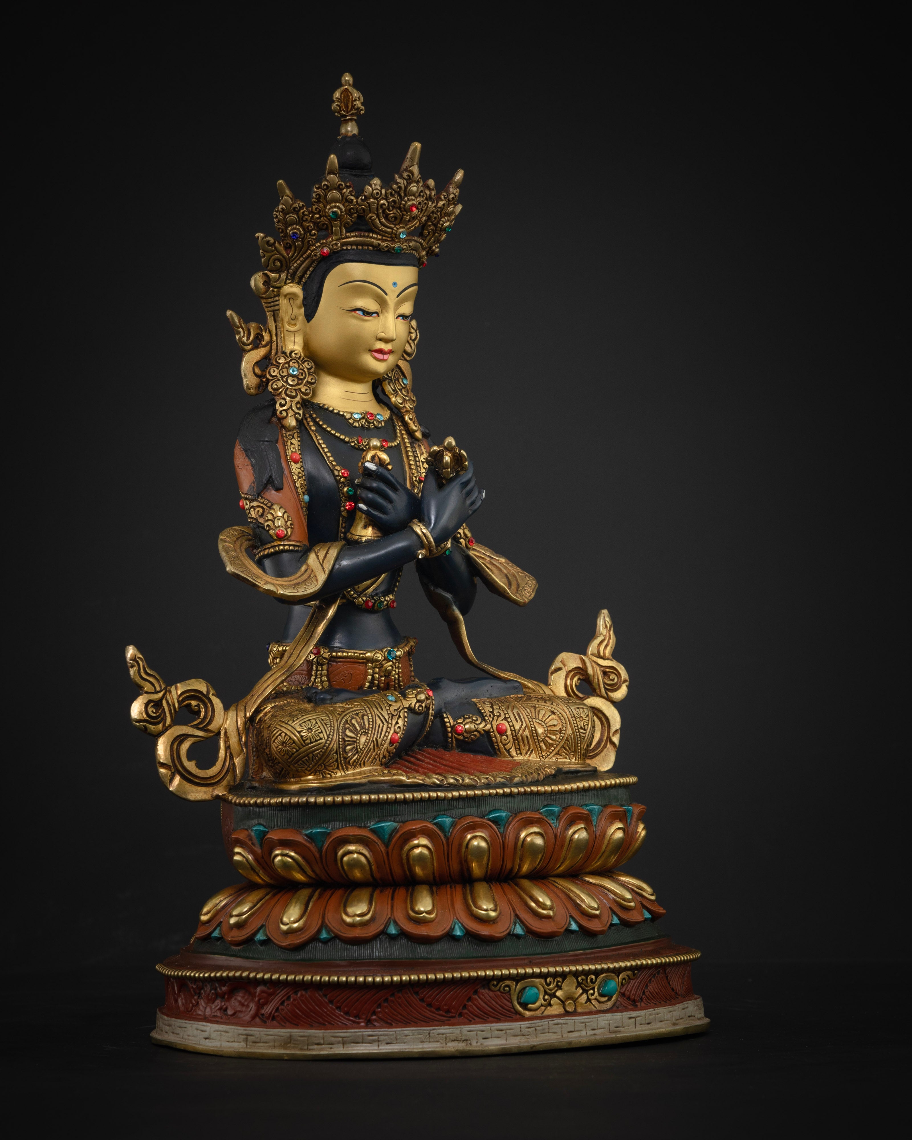 The 38cm tall Vajradhara statue, highlighting the intricate craftsmanship, colorful accents, and elegant gem-inlaid ornaments.