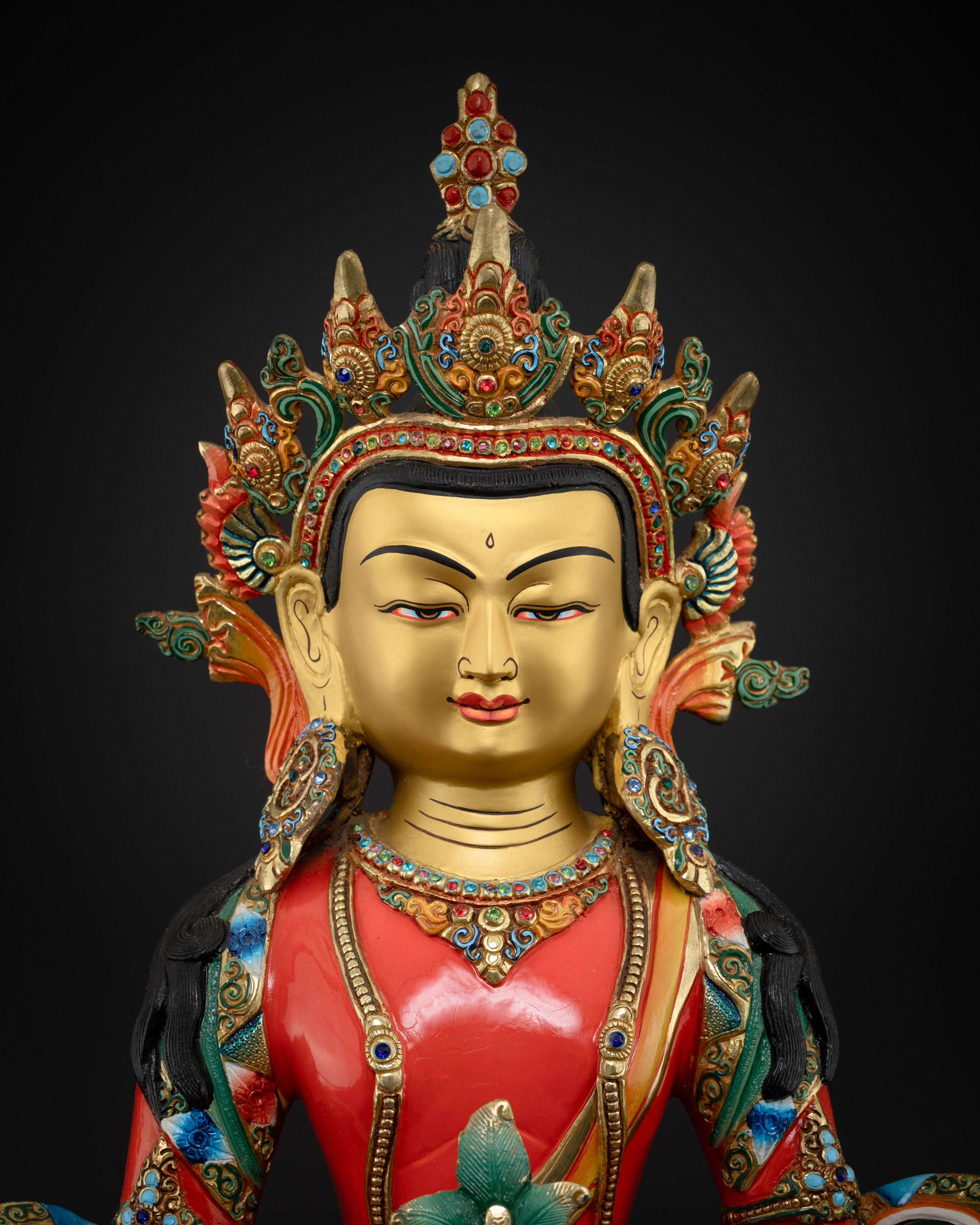The Amitayus Buddha’s ornate crown and facial features, showcasing intricate gold-painted details, semi-precious stone embellishments, and the serene, compassionate expression of Nepalese artistry.