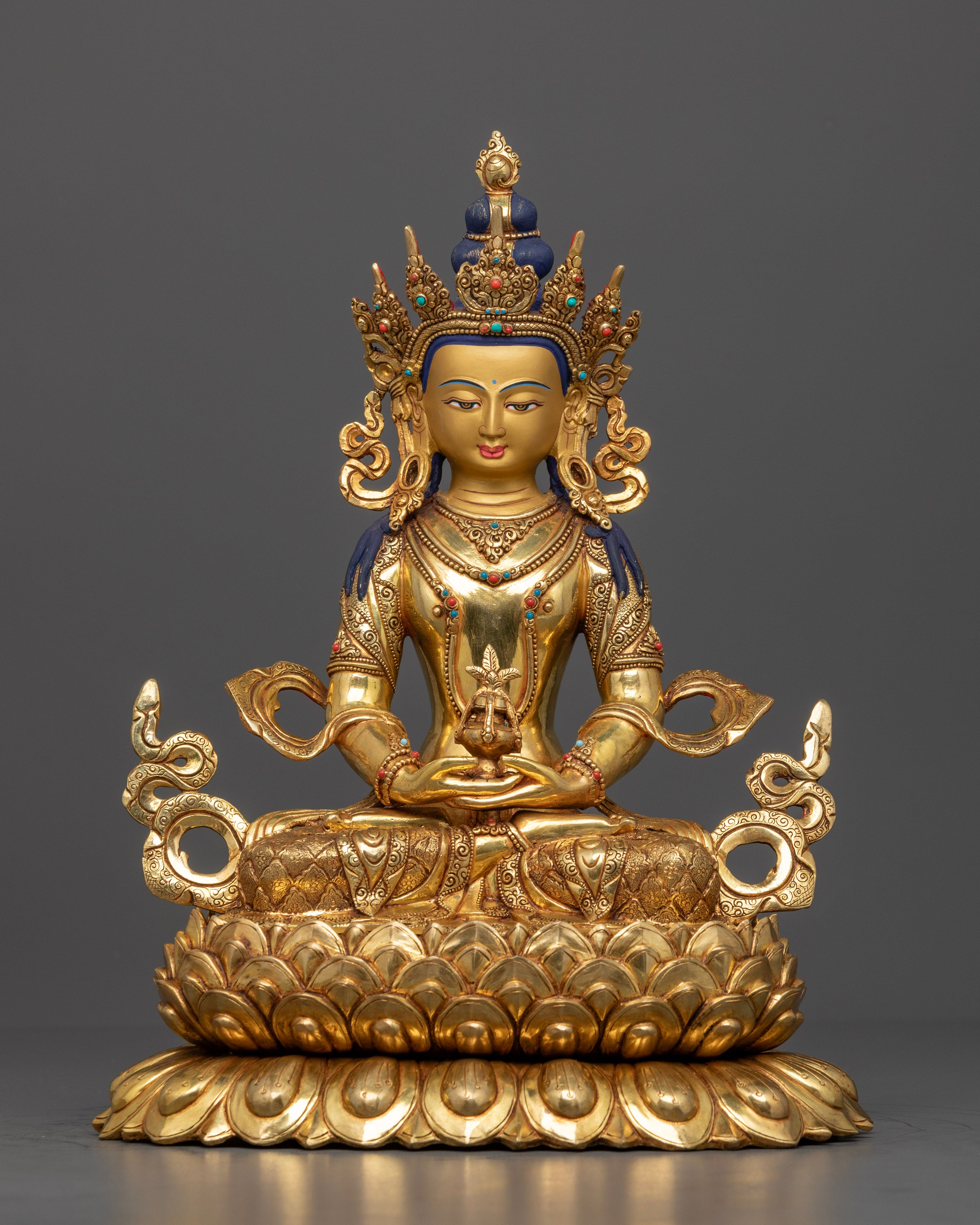 The Amitayus statue, seated serenely on a lotus throne symbolizing purity, holding a nectar vessel of immortality, with intricate gold accents and semi-precious stones enhancing the statue's spiritual elegance.