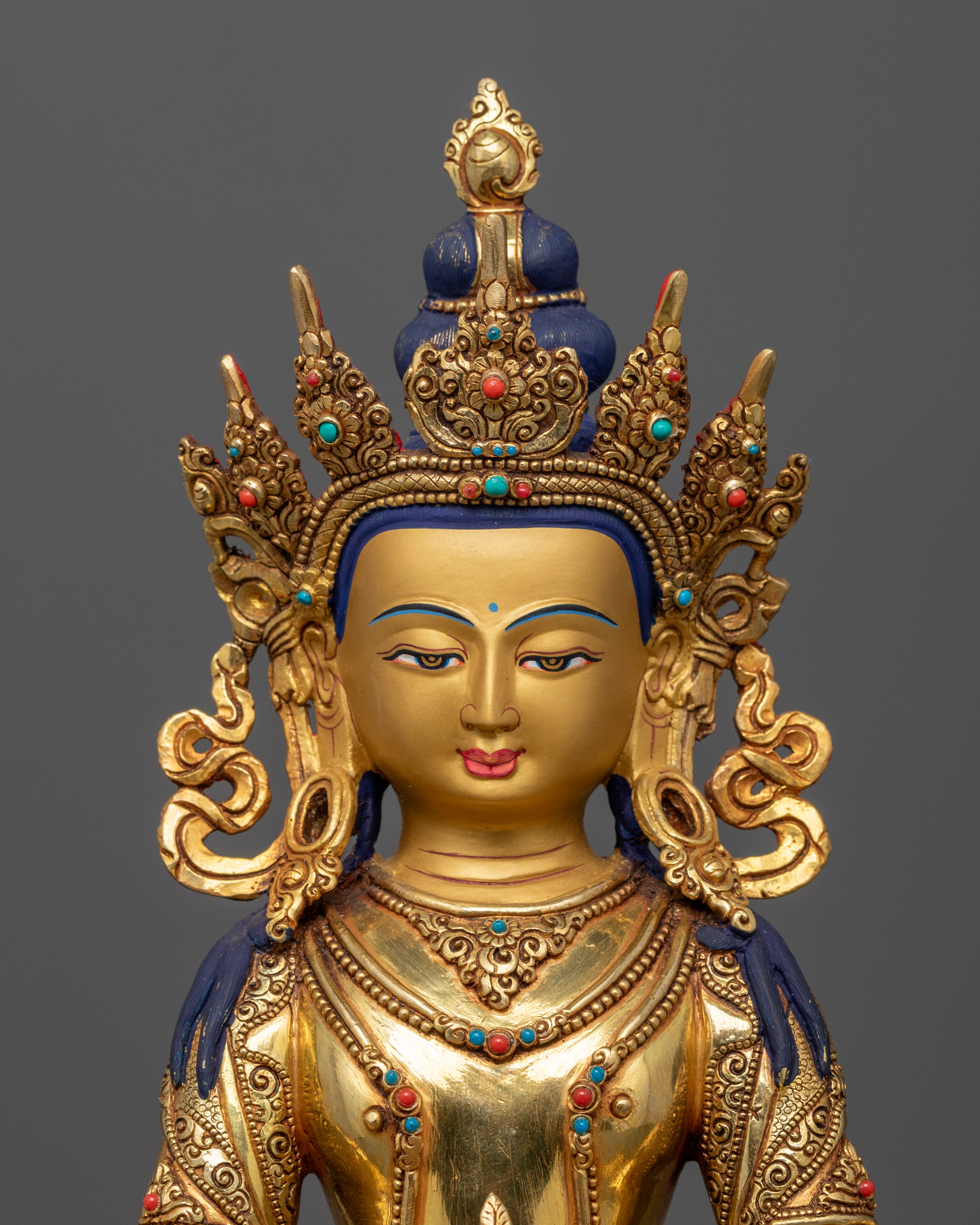 The Amitayus statue’s calm expression and detailed handwork, focusing on the nectar vessel adorned with semi-precious stones, representing vitality, longevity, and the blessings of infinite life.