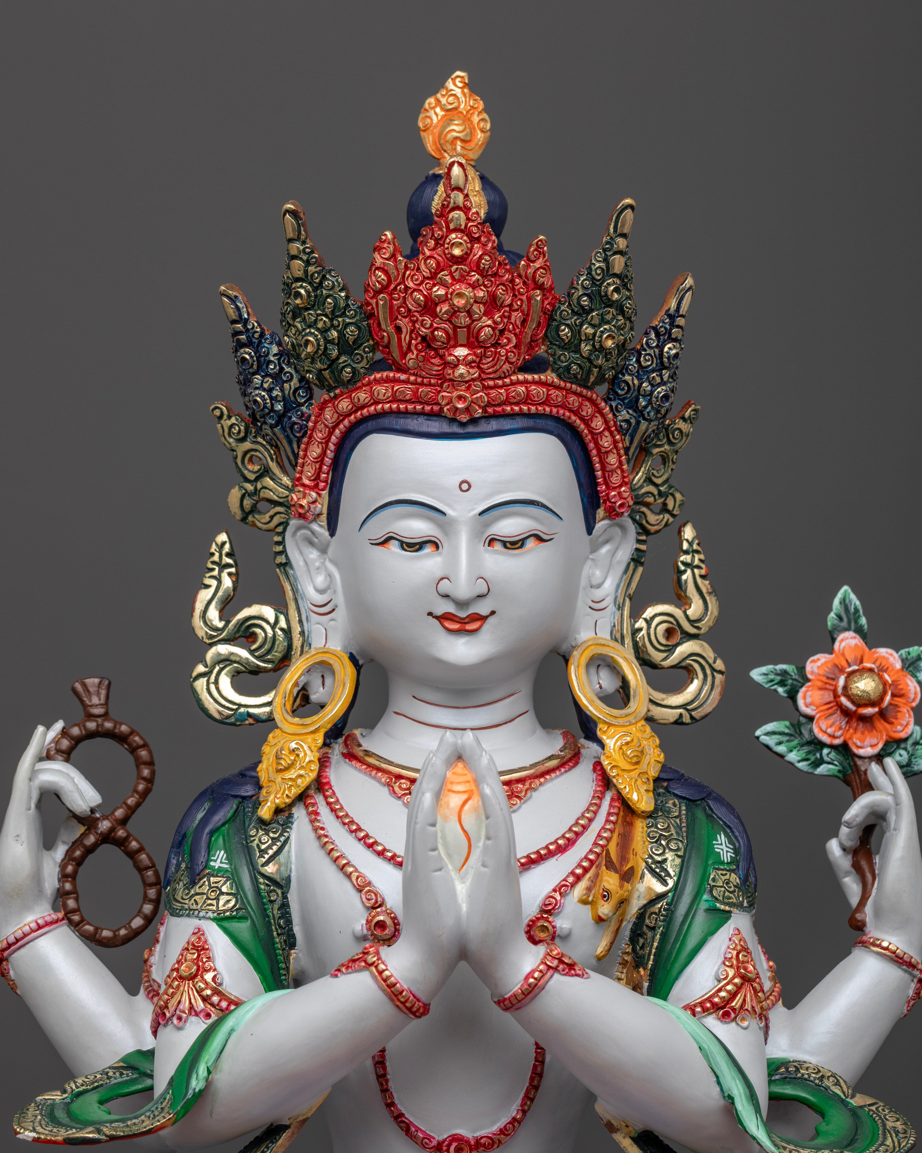 The Chenrezig statue’s serene expression and ornate details, highlighting the vibrant colors and fine craftsmanship of Nepalese artisans.