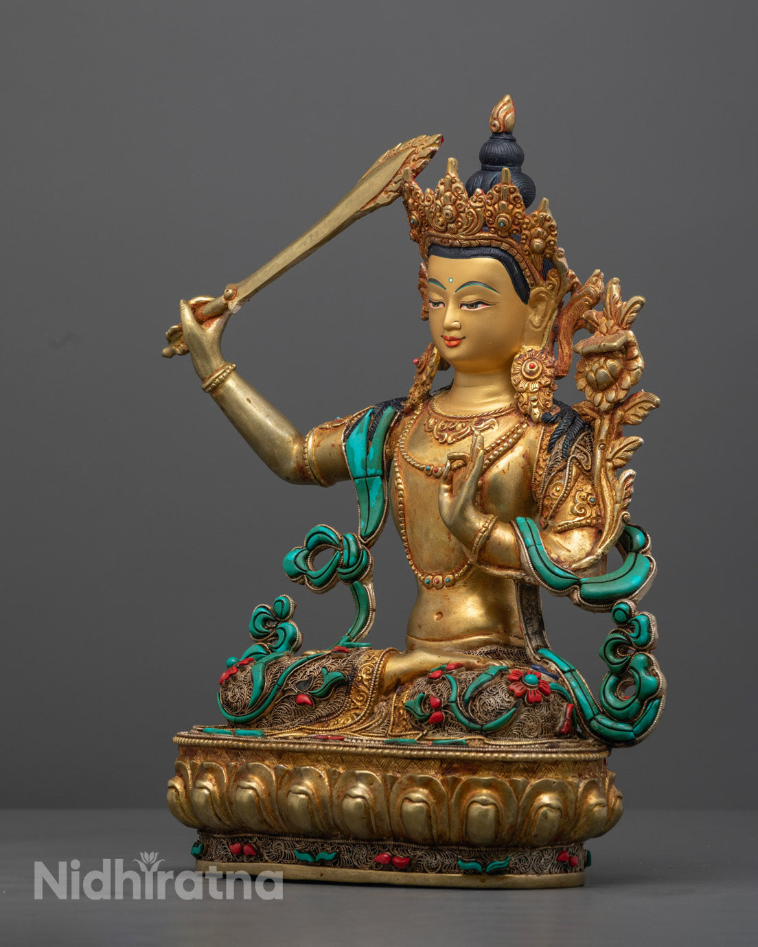 The Manjushri sculpture revealing the hollow section for mantra placement, emphasizing the spiritual functionality and artisanal detail of the statue.