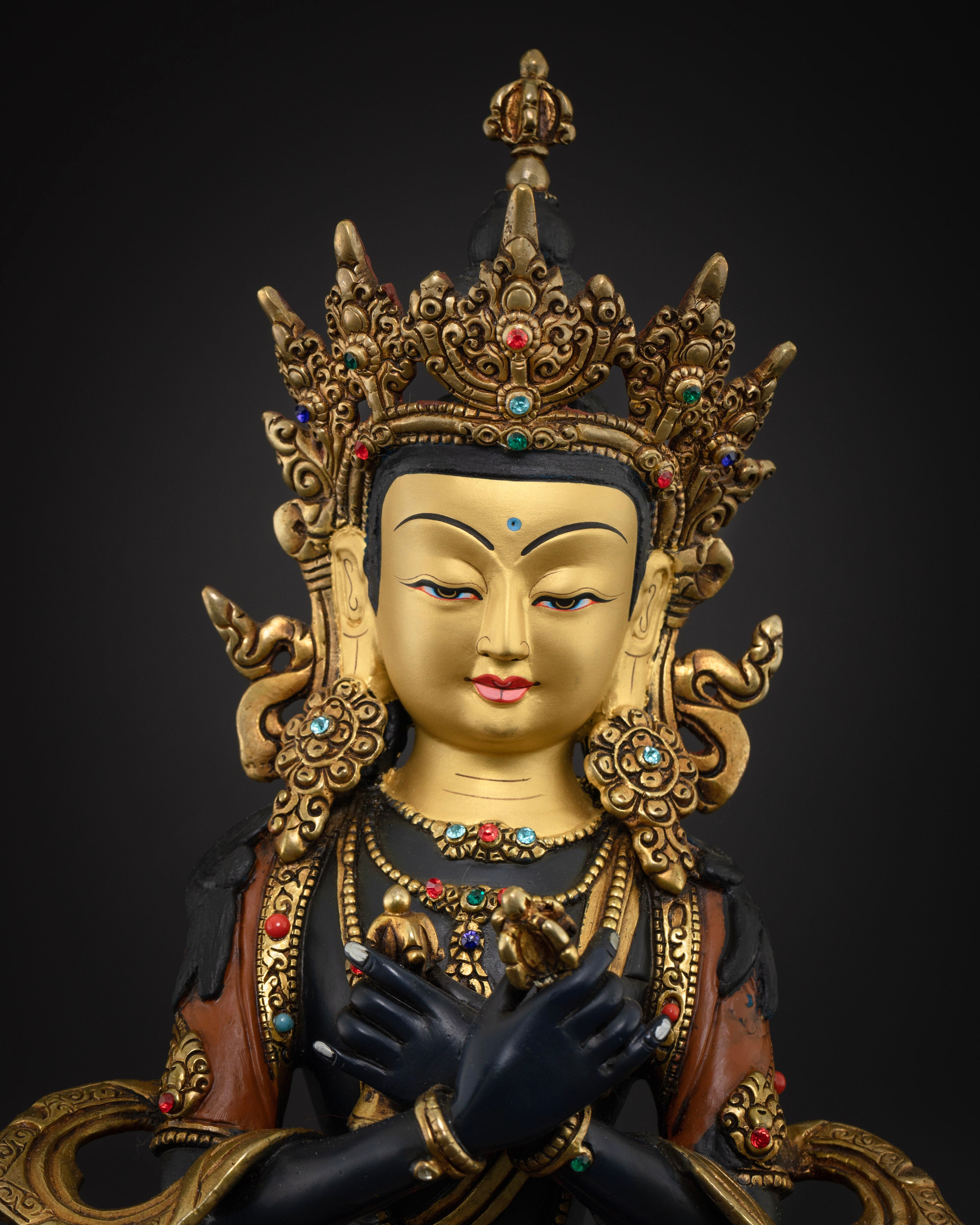The Vajradhara statue’s serene, gold-plated face, showcasing refined detailing and traditional Nepalese artistry.