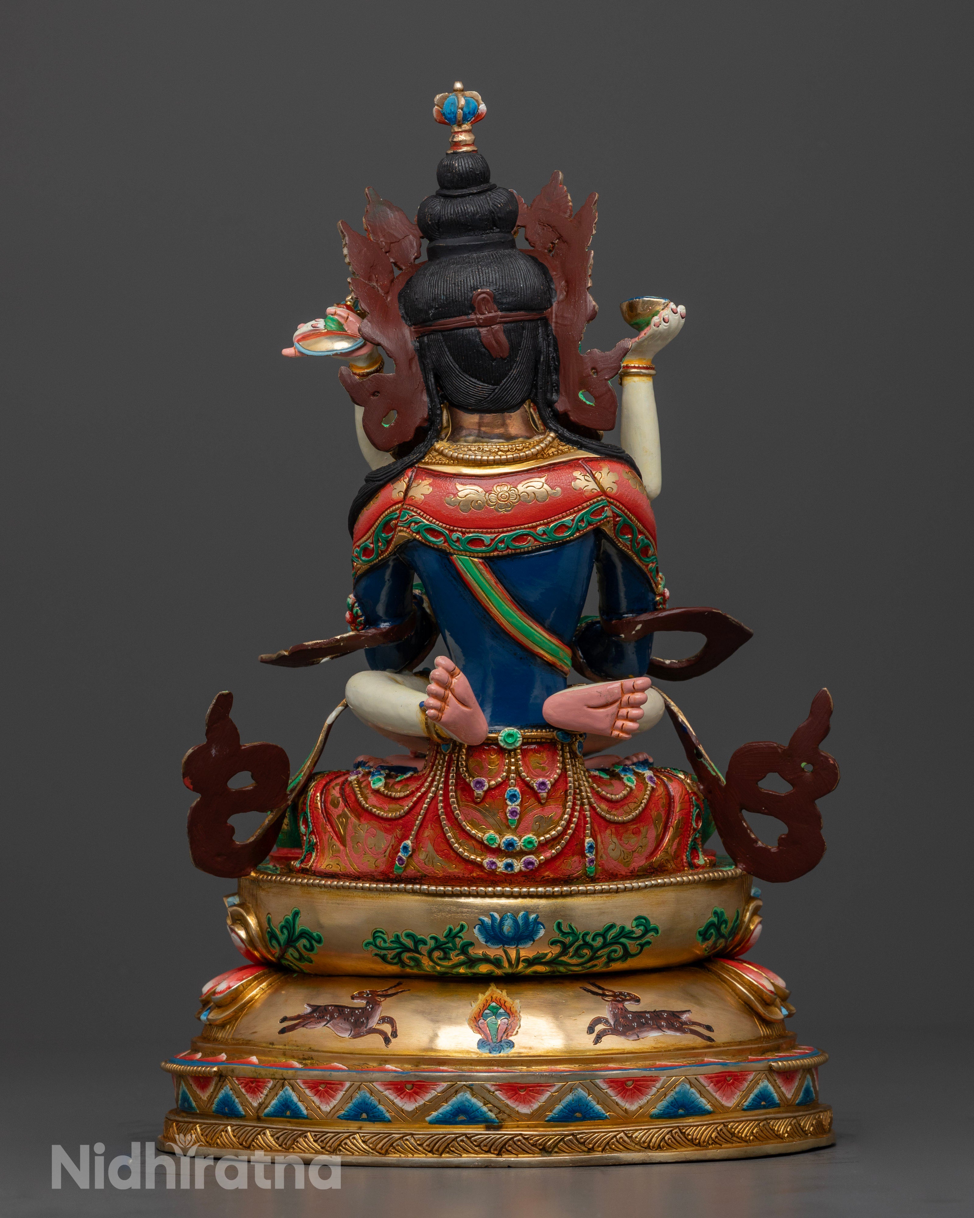The Vajradhara statue seated elegantly on a lotus throne, symbolizing purity and spiritual ascension, adorned with intricate details and semi-precious stones.