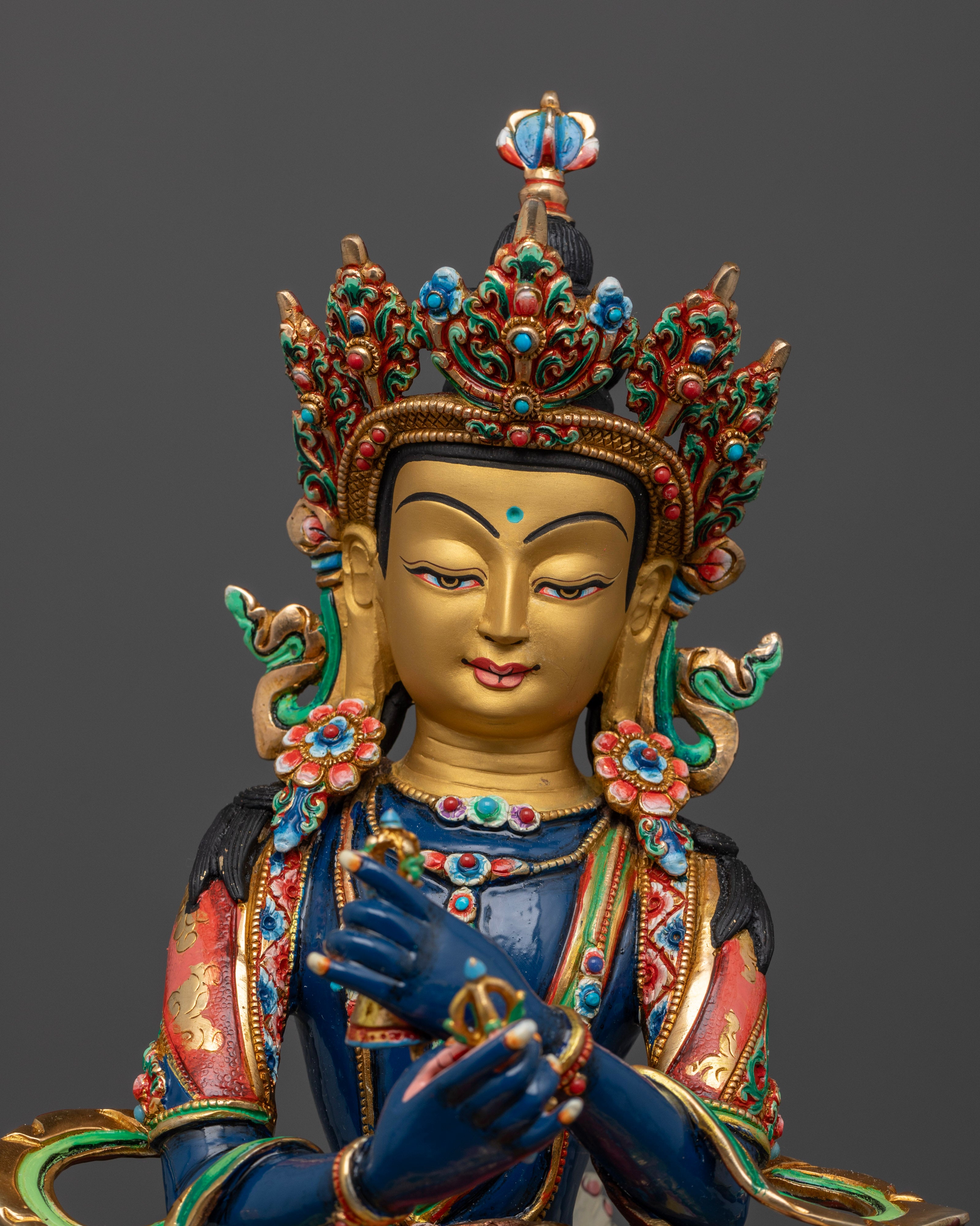 Vajradhara’s hands holding crossed vajras, representing the unity of wisdom and method, with vibrant colors enhancing the divine presence