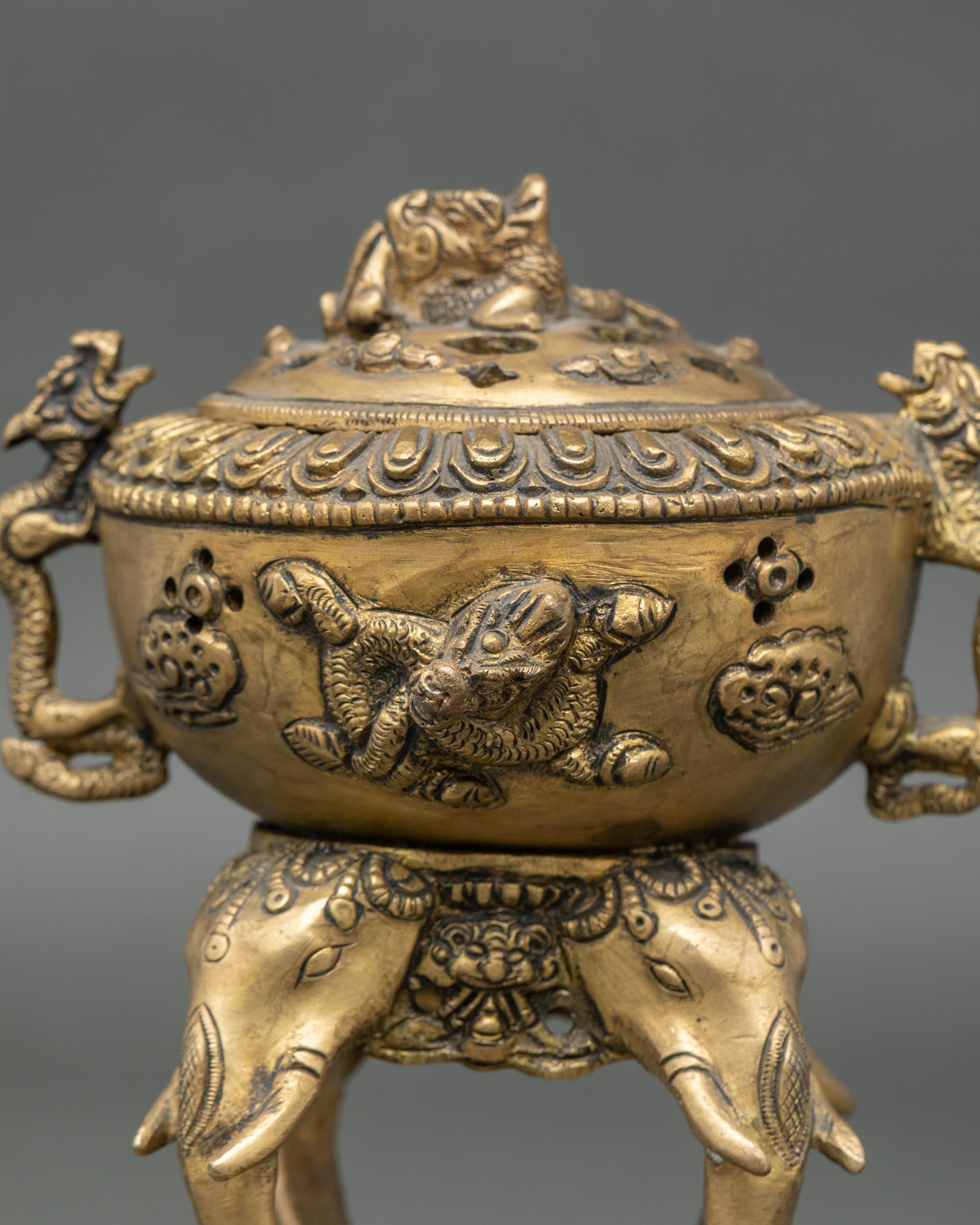 Three-quarter front view of elephant base brass incense burner Tibetan Buddhist censer Nepal