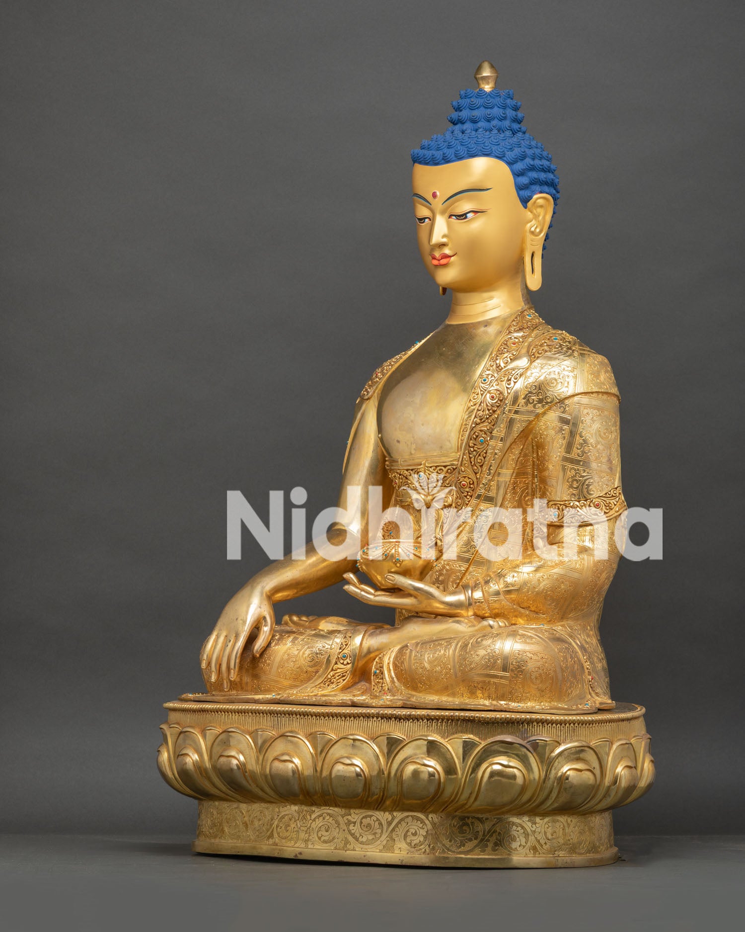 Three-quarter angle view of Nepalese gold gilded Shakyamuni Buddha statue