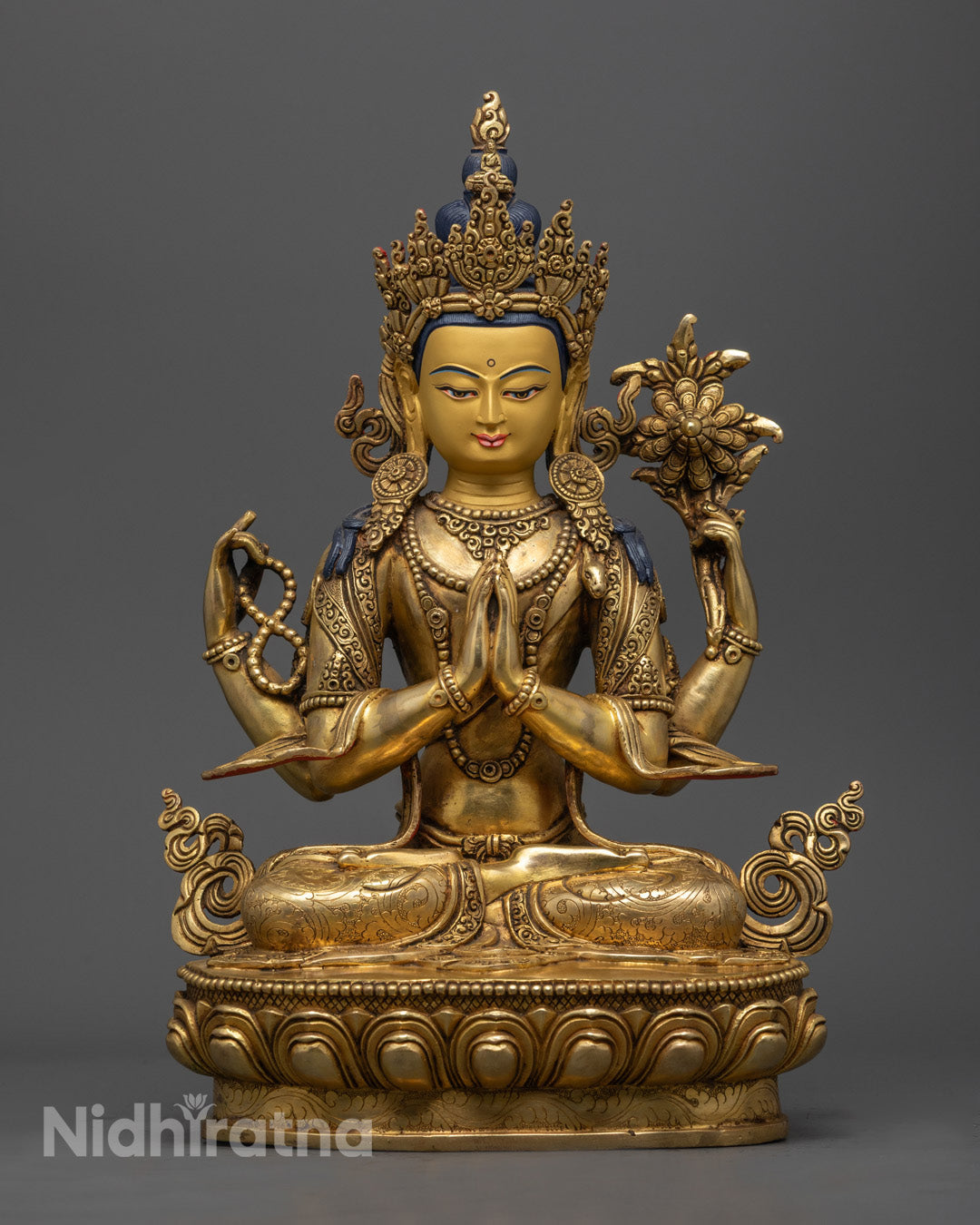 Tibetan Chenrezig Deity Statue showing pure gold-gilded face and body with vibrant acrylic colors