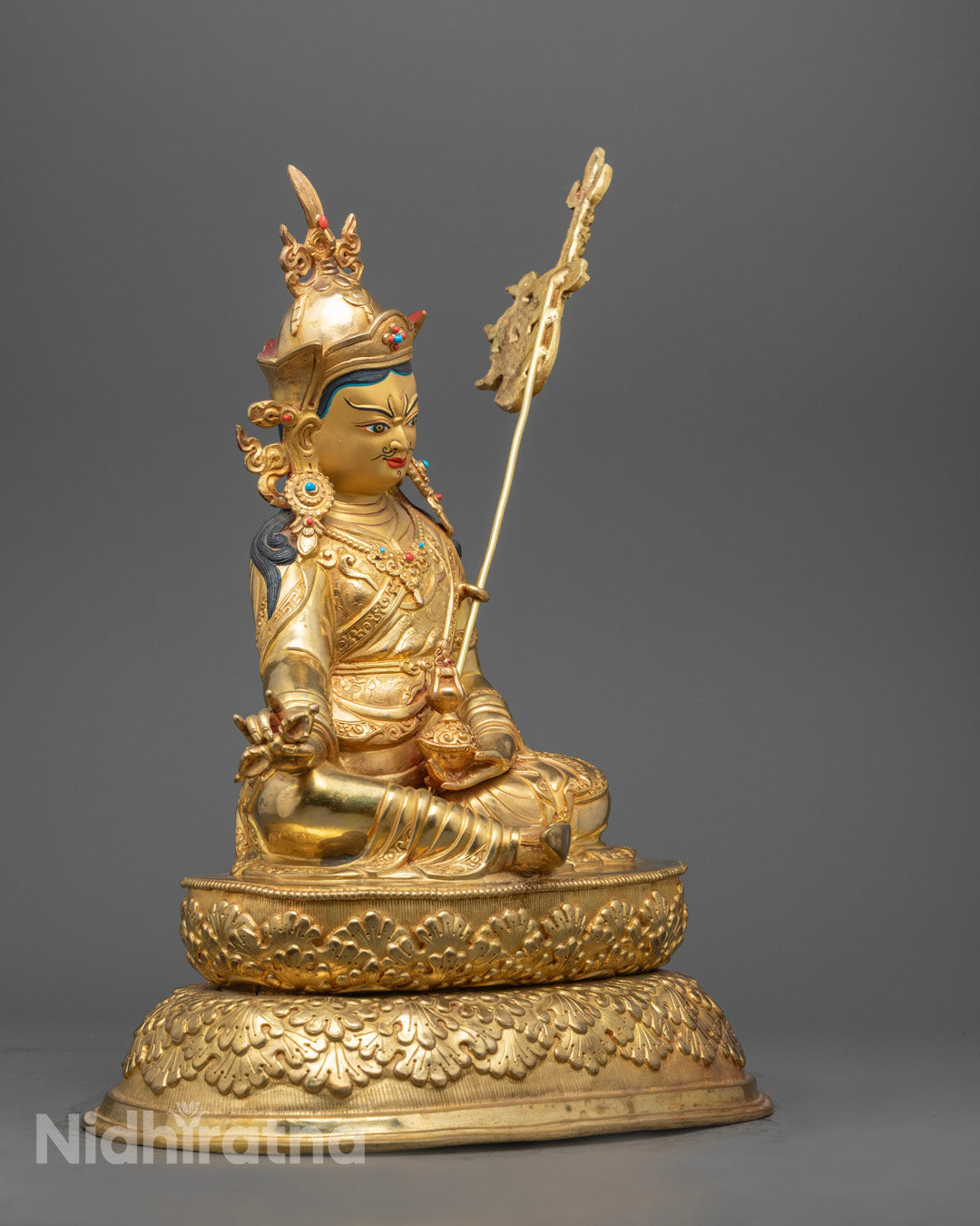Tibetan Guru Rinpoche statue adorned with semi-precious stones and rich acrylic colors – Symbol of wisdom, protection, and spiritual transformation