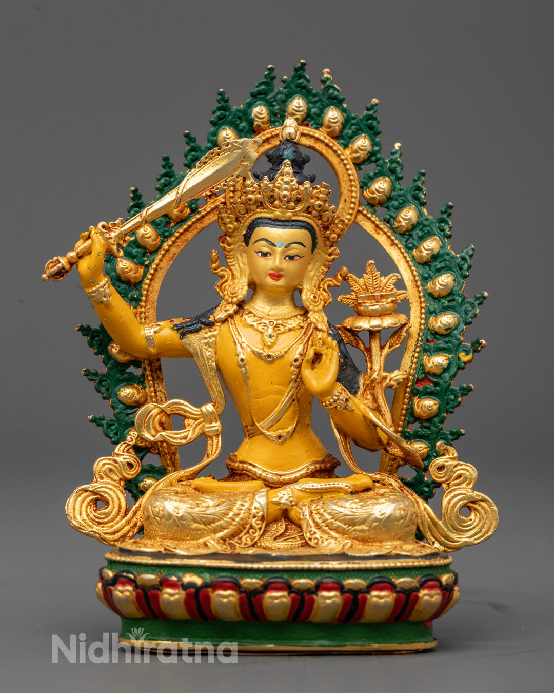Tibetan Manjushri statue with gold-plated face seated on lotus throne symbol of wisdom and clarity