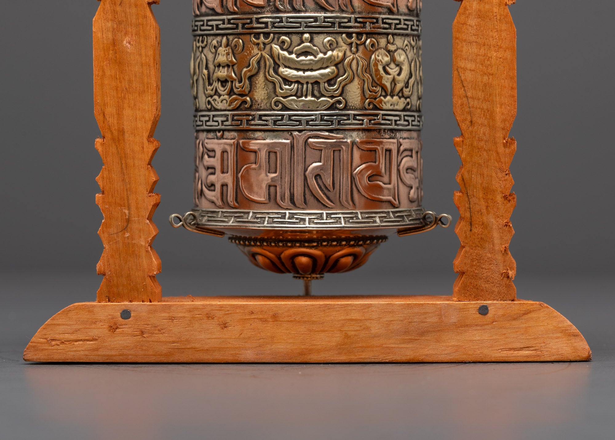 Top-down view of handcrafted Auspicious Prayer Wheel in shrine setting with spiritual glow