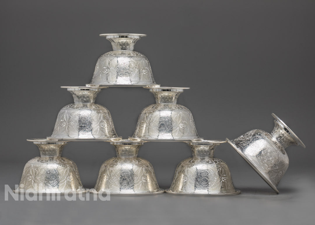 Top-down view of pure silver water offering bowl displaying its polished interior