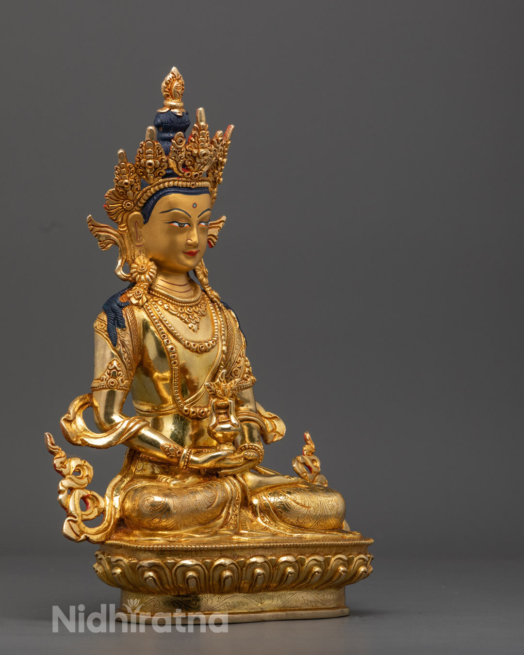 Traditional Nepalese Amitayus Buddha sculpture with hollow chamber for auspicious mantras, richly colored with acrylic paints.