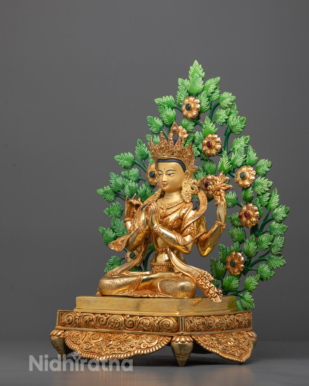 Side view of Traditional Nepalese Chenrezig statue with gold-plated finish and vibrant green
