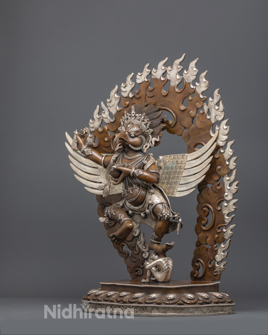 Traditional lost wax method Garuda sculpture with detailed feathers and vivid red and gold acrylic colors
