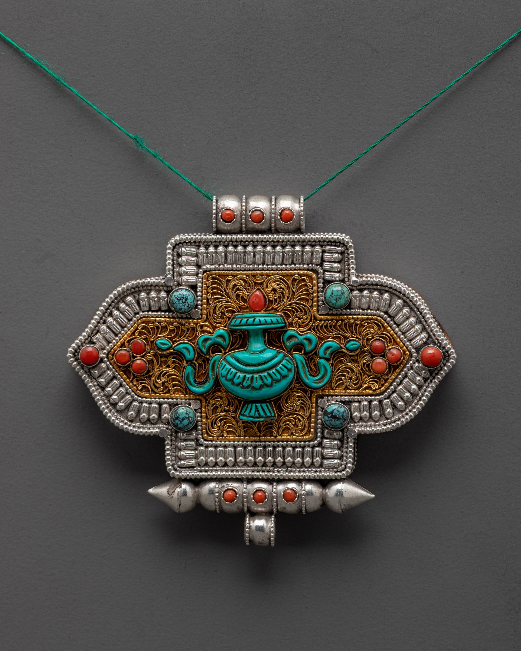 Treasure Vase Locket front view showing coral, turquoise, and gold filigree design