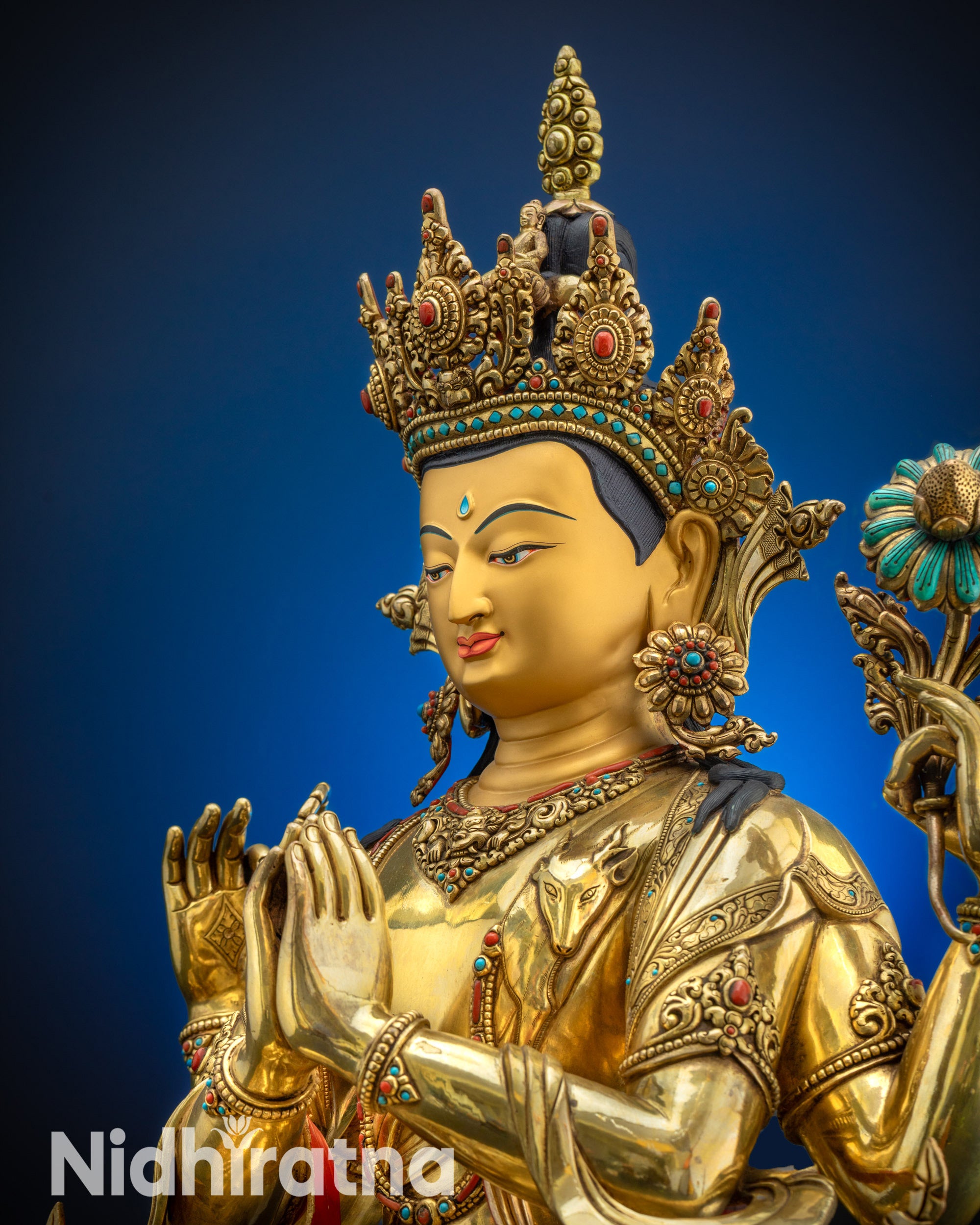 Upper close up of Avalokiteshvara Bodhisattva face gold-gilded meditation idol