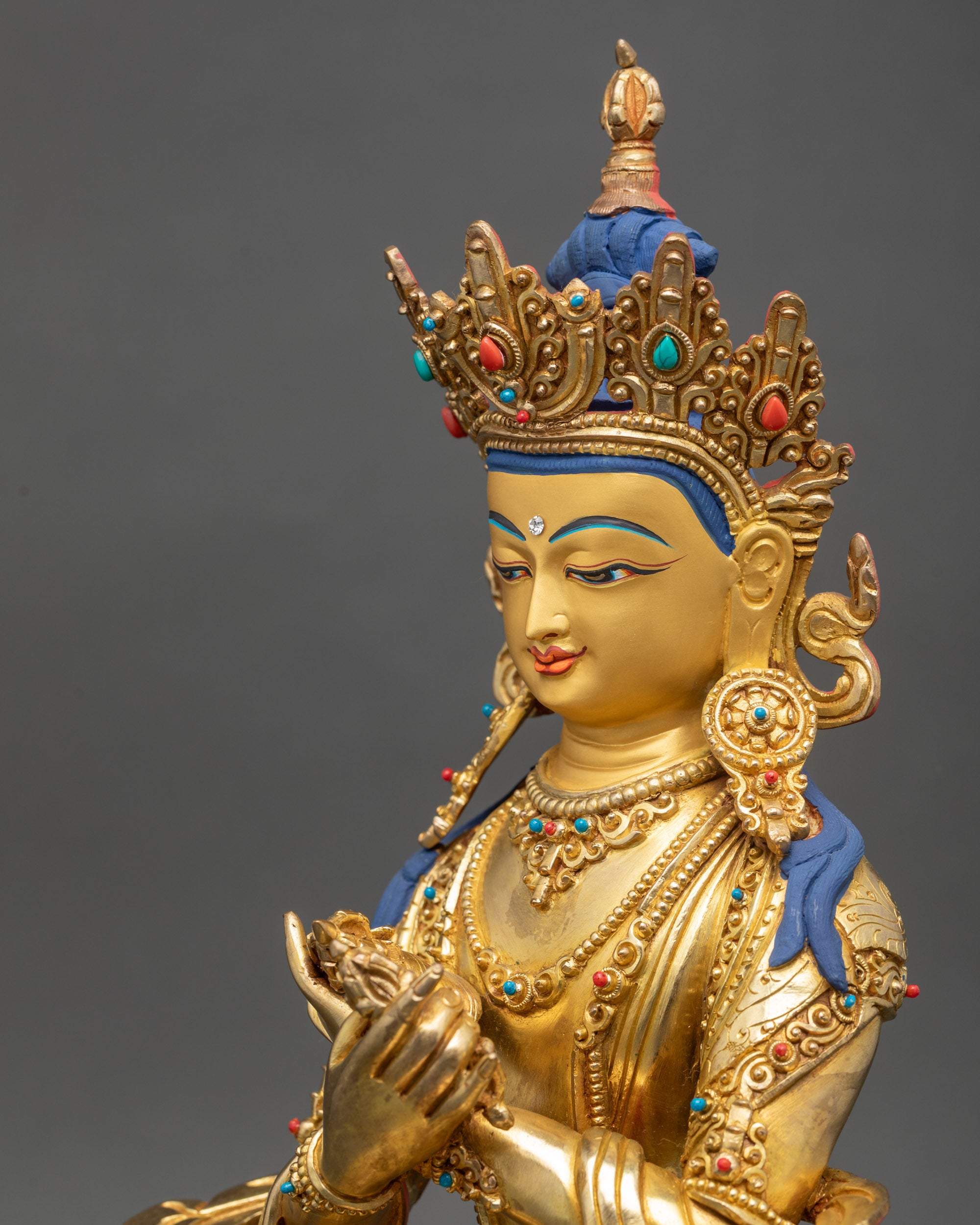 Vajradhara Buddha Statue detailed close up of calm gold-gilded face