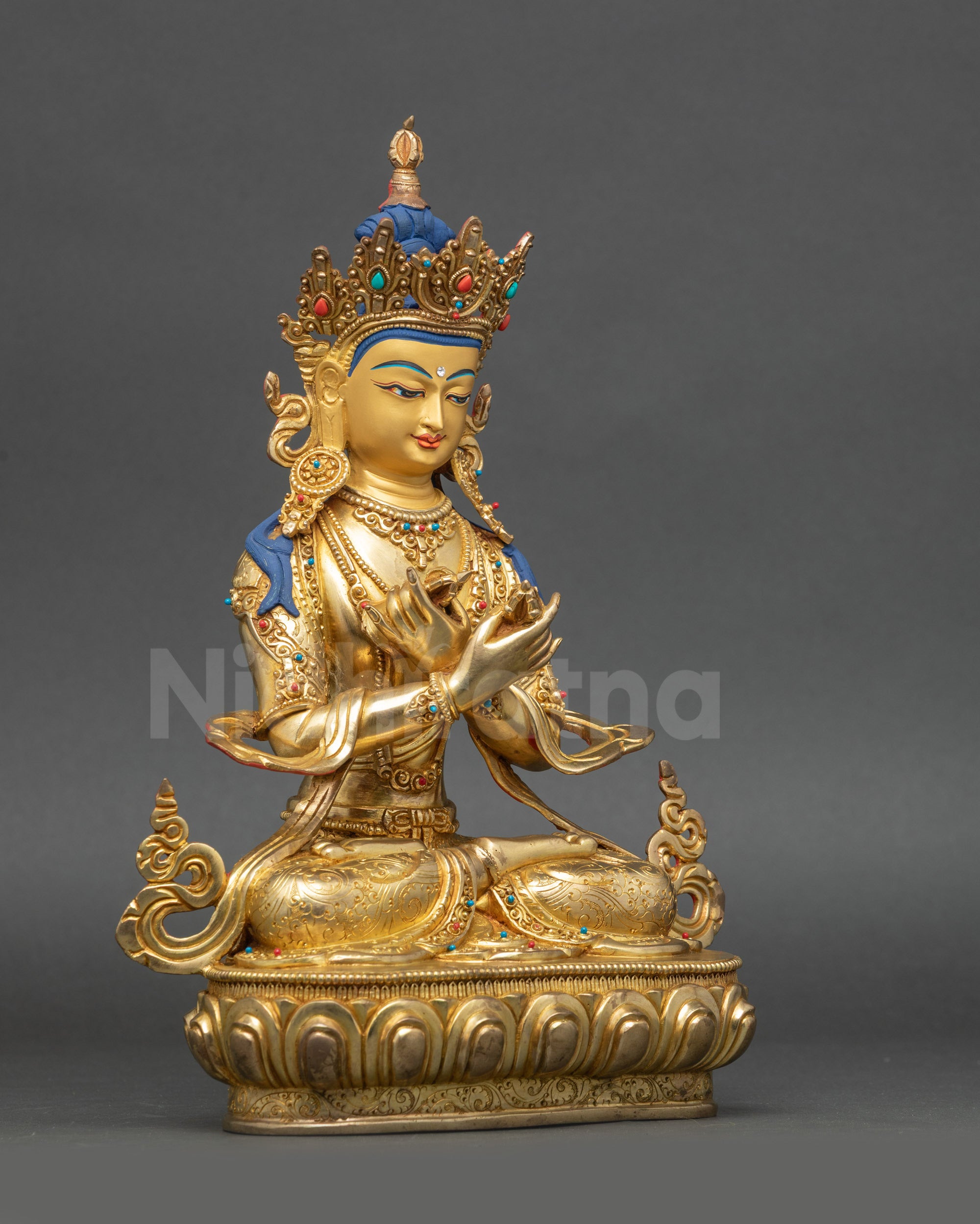 Vajradhara Statue side close up showing Dorje Ghanta and flowing robe