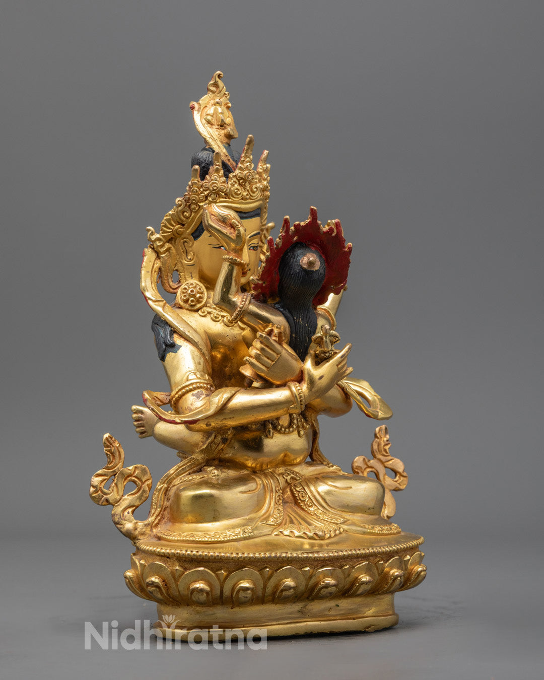 Vajradhara with Consort statue highlighting the serene expressions and intricate ornamentation of traditional Himalayan art.