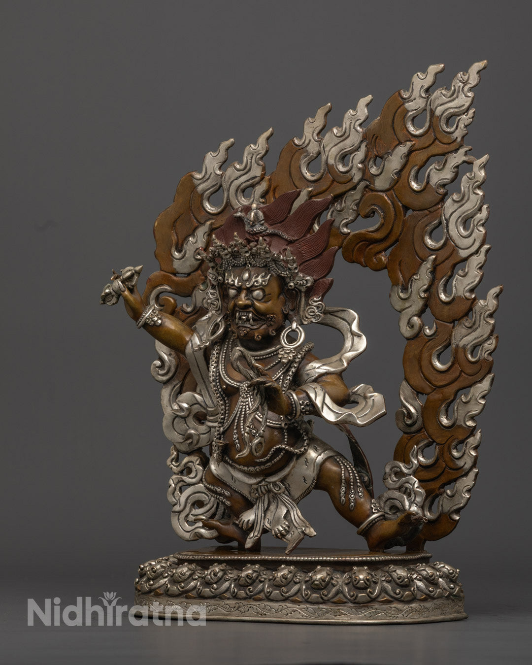 Intricate carvings on Vajrapani statue’s robe and jewelry, showcasing traditional Himalayan craftsmanship and fine detailing