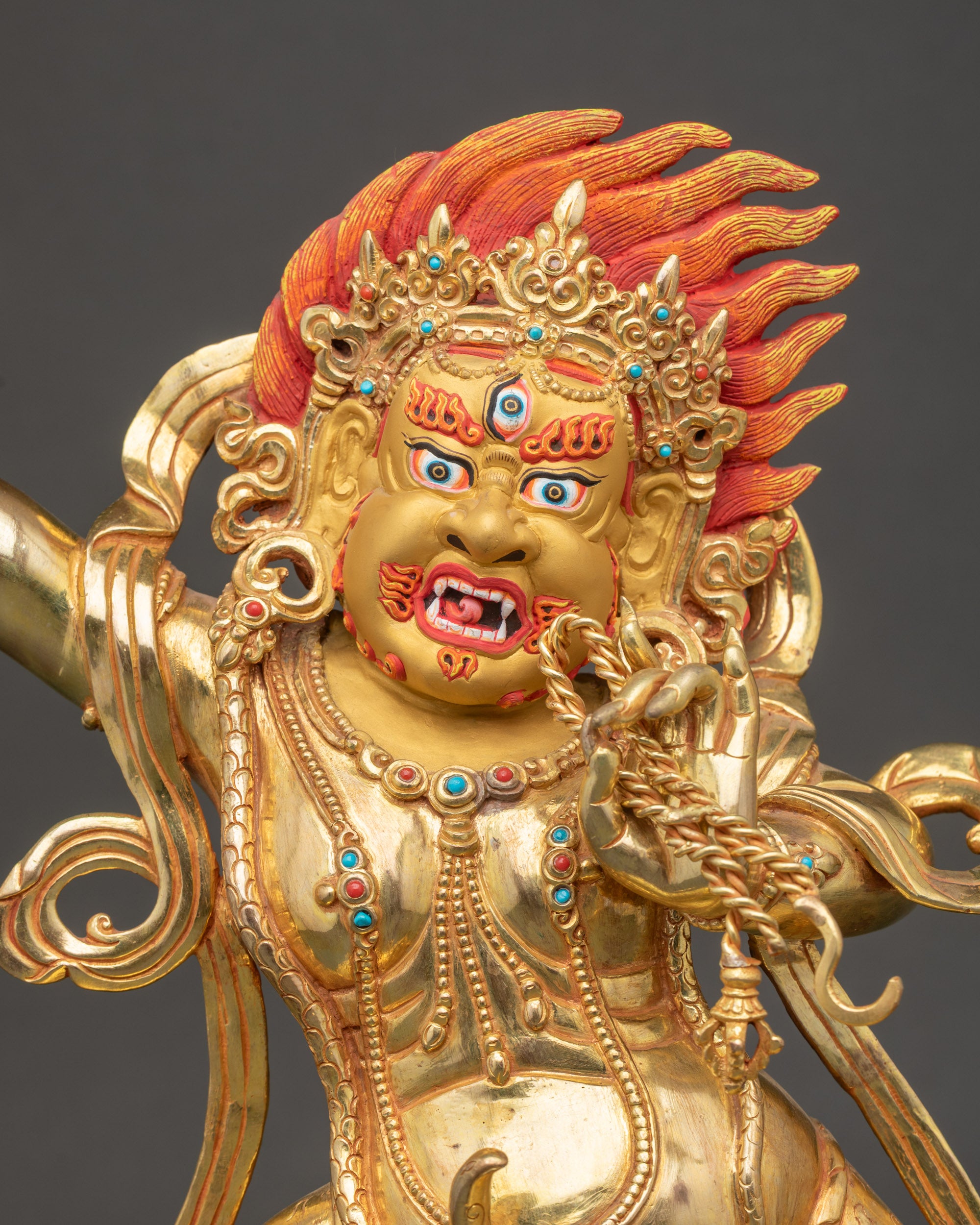 Vajrapani face with wrathful expression, third eye, and gold-painted details