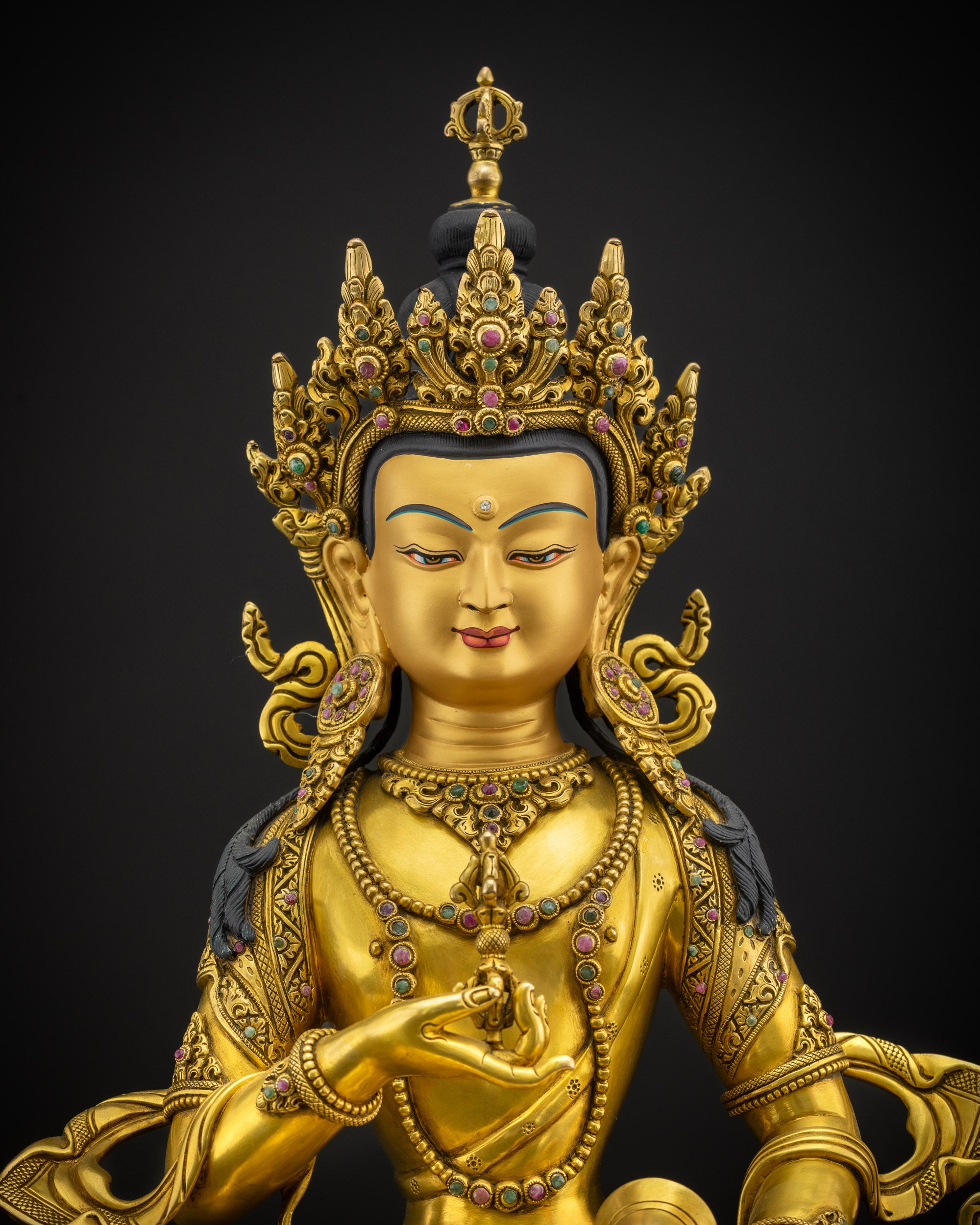 Close view of Vajrasattva statue showing gold fire-gilded body and detailed Nepalese craftsmanship