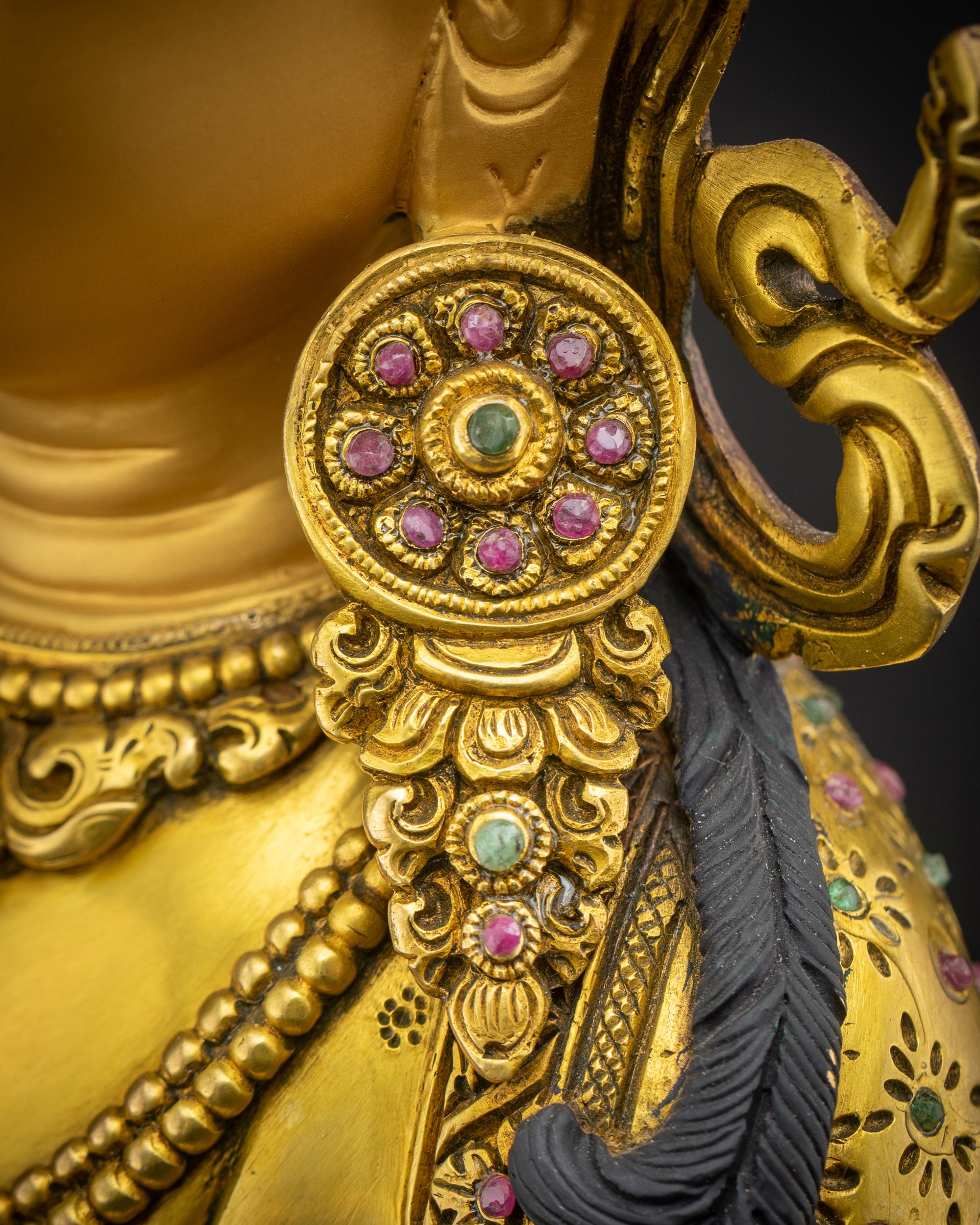 Close up of Vajrasattva Dorje Sempa earrings showing fine carving and Nepalese craftsmanship