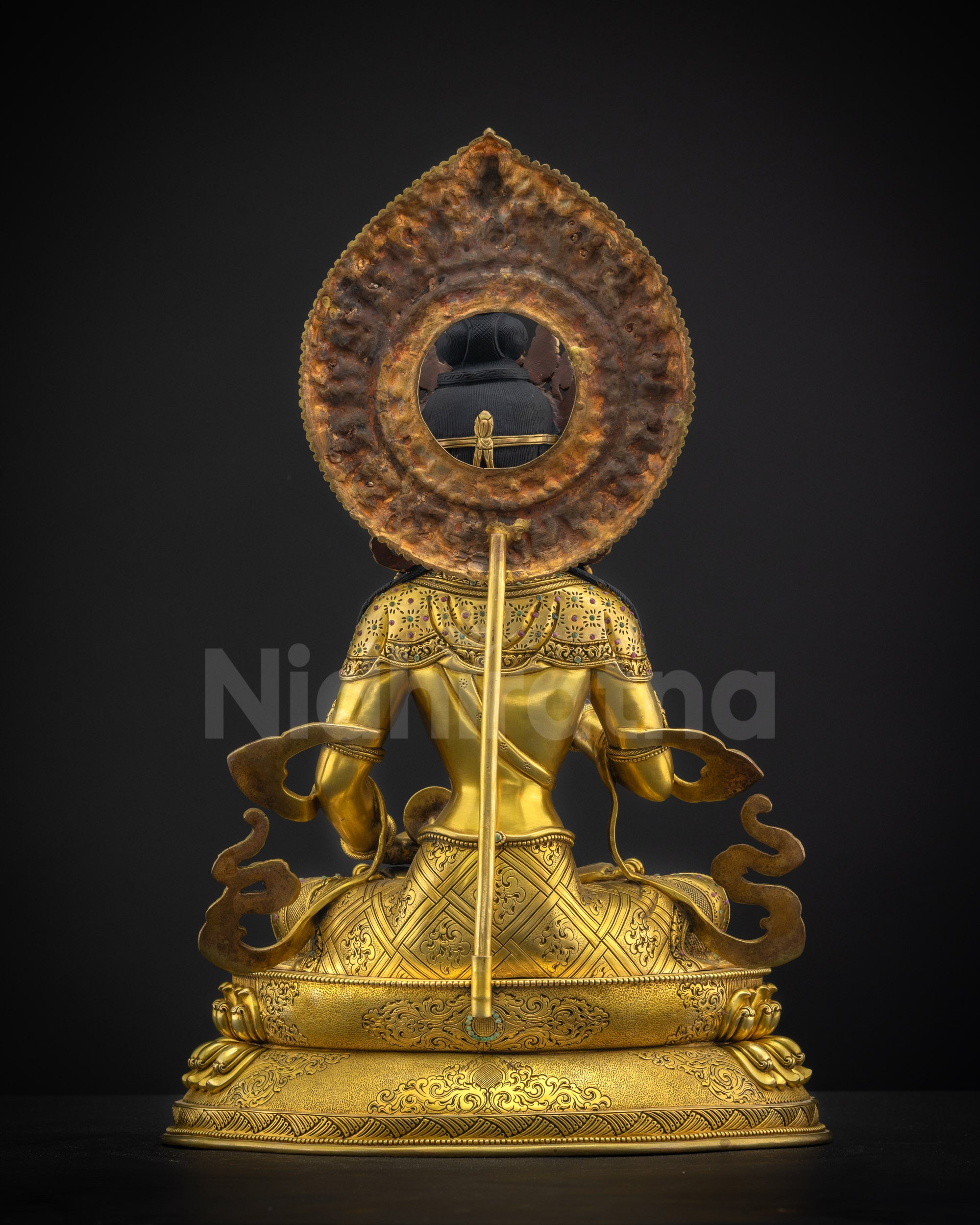 Back view of Vajrasattva statue highlighting floral halo and traditional Himalayan casting