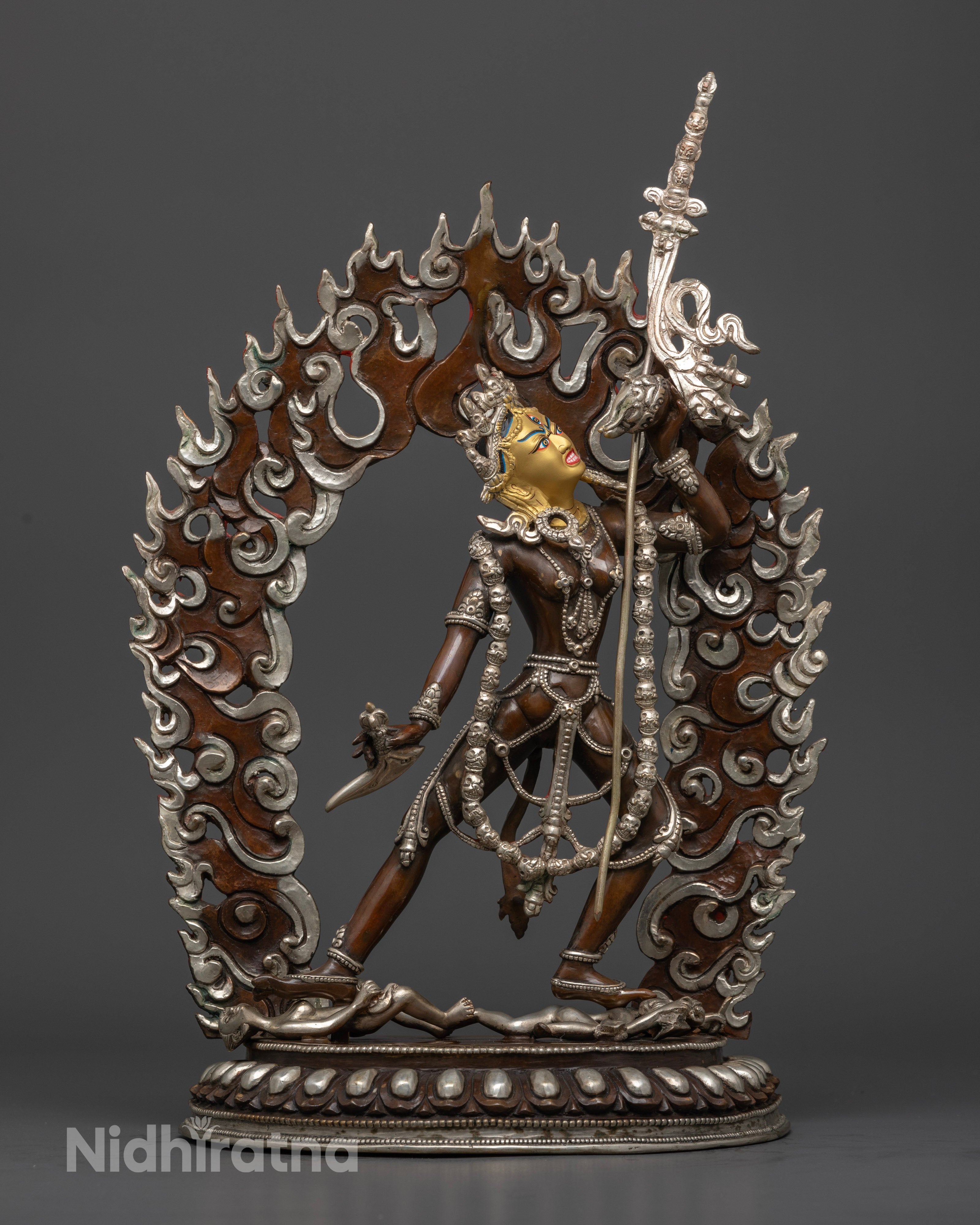 Vajrayogini’s upper body, highlighting her serene yet powerful expression, the objects she holds in each hand representing the balance of wisdom and compassion, with detailed silver and colorful acrylic accents."