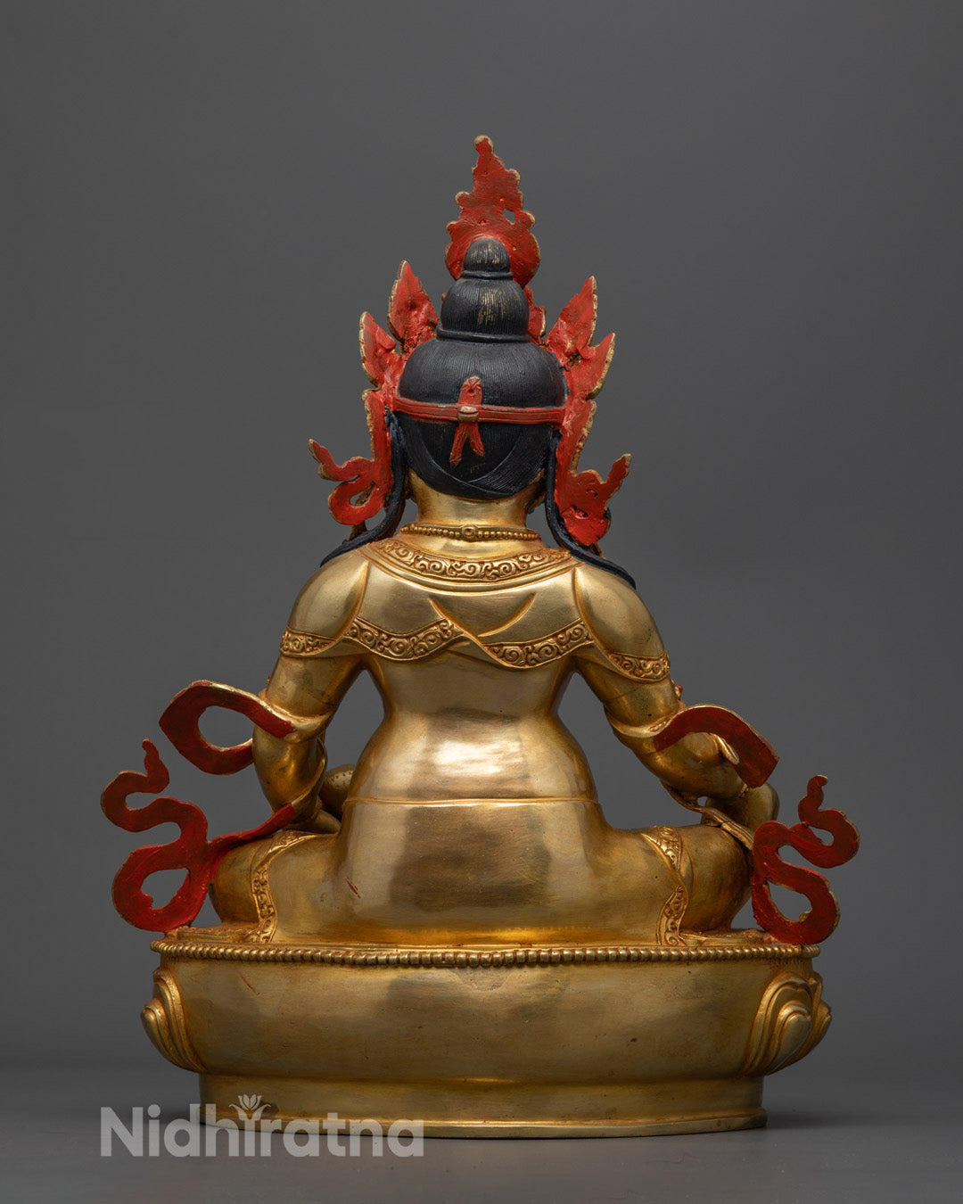 Vibrantly colored Dzambhala Statue painted with acrylics, showcasing detailed craftsmanship and adorned with semi-precious stones.