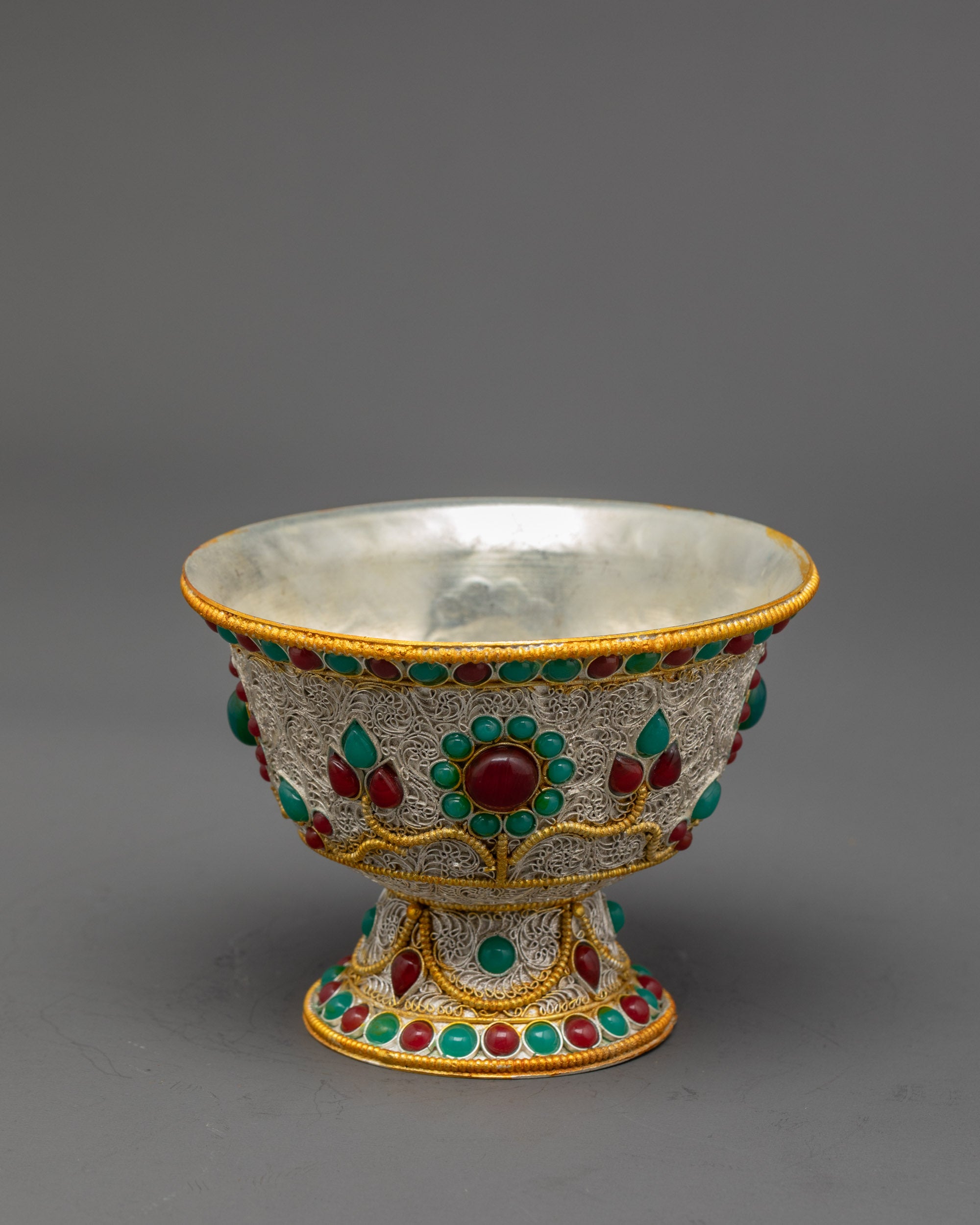 Side view of Silver-Plated Water Offering Bowl highlighting gold filigree patterns