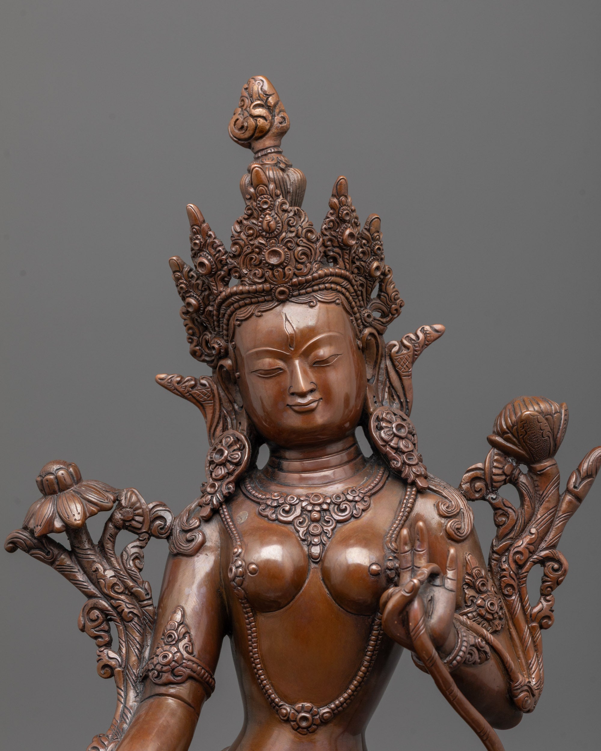 close-up of white tara face showing oxidized copper detail and intricate carvings