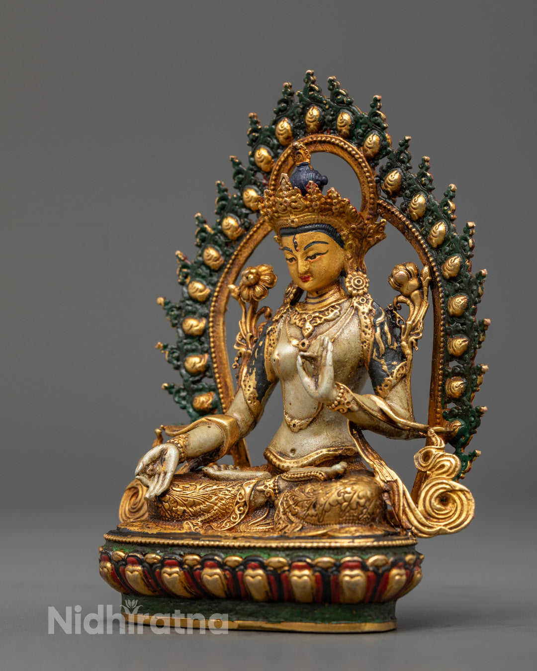 White Tara sculpture seated on a lotus throne with a hollow section for mantra filling and concentration, painted with vibrant acrylic colors