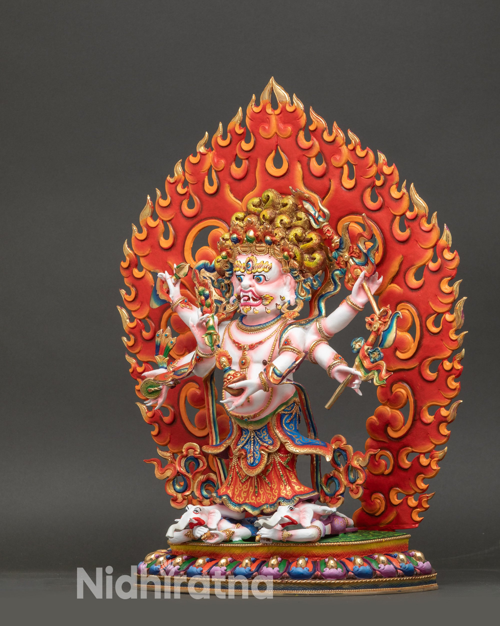 White Mahakala sculpture with trident, skull cup, hand drum, and flaming halo