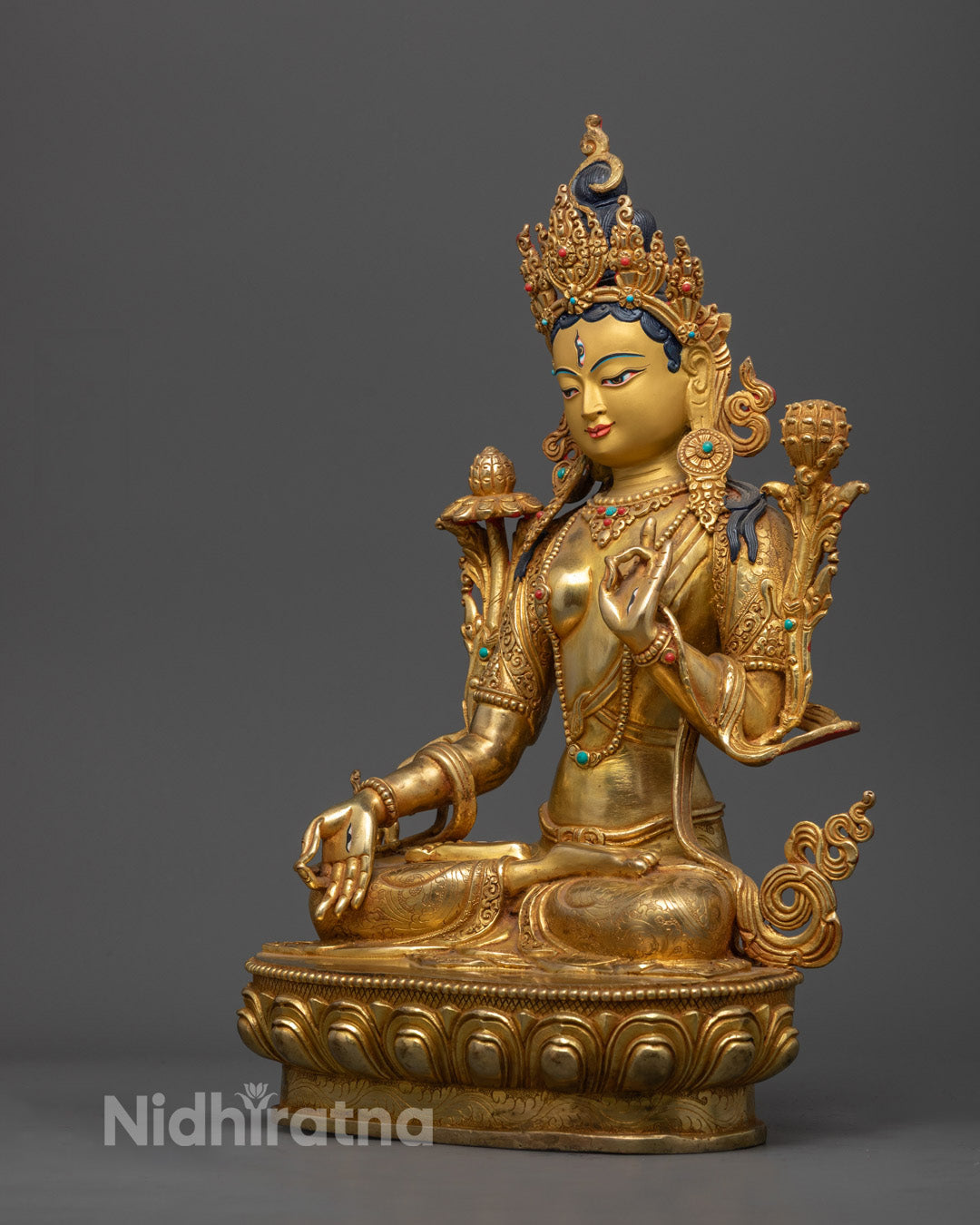 White Tara's pure gold-gilded face with five-jeweled crown and serene expression, symbolizing divine compassion and wisdom