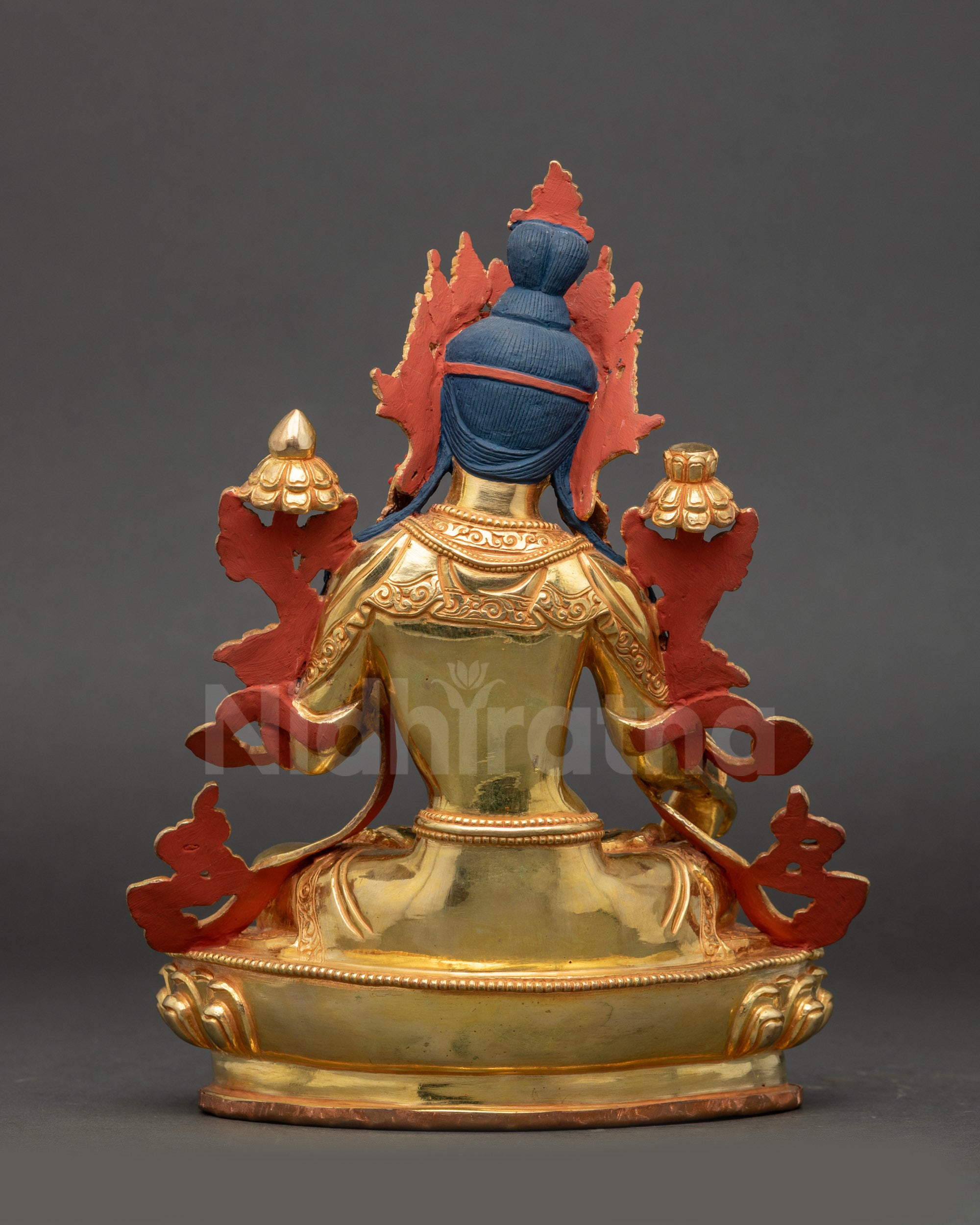 White Tara statue back view showing intricately carved robes and design