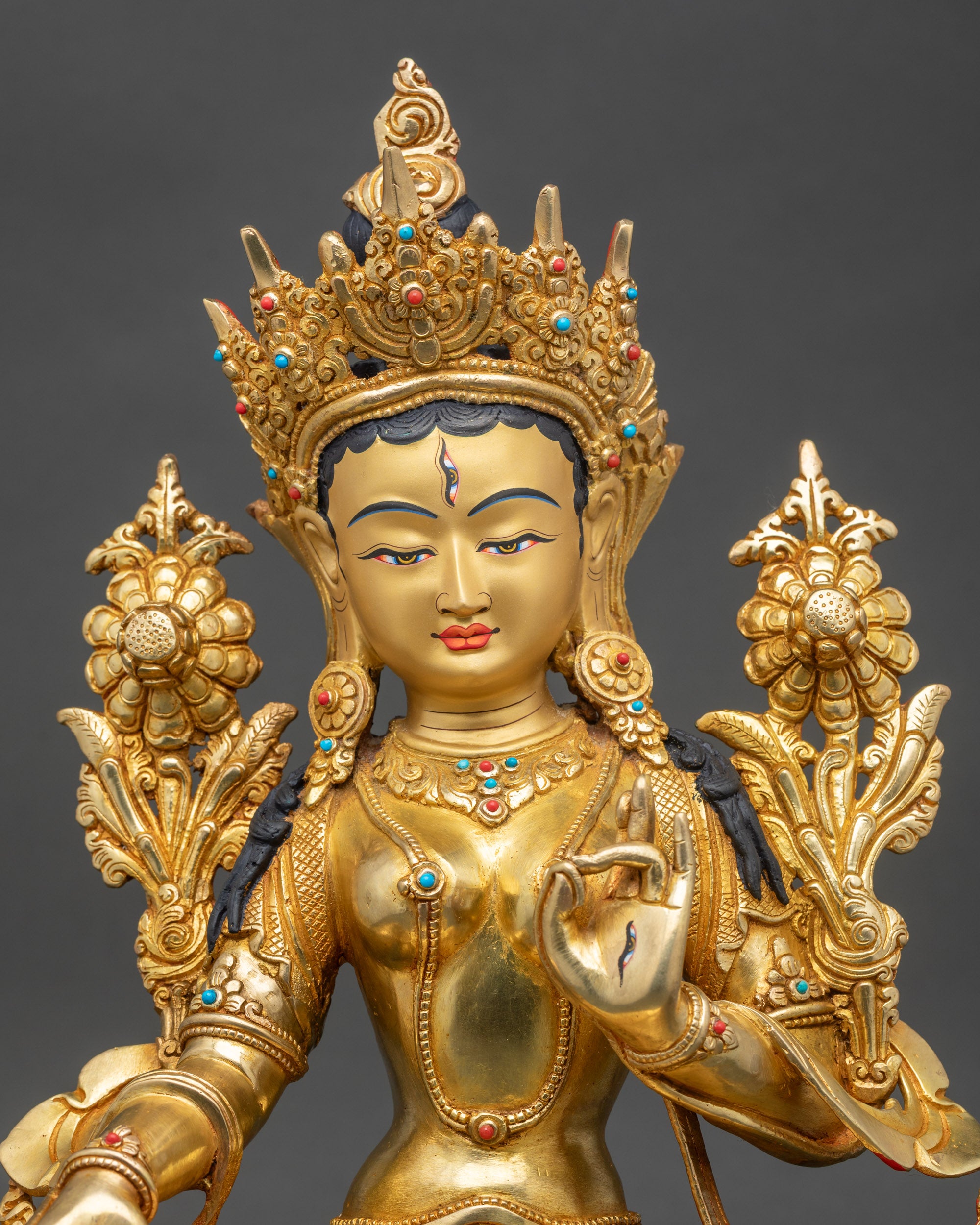 White Tara statue close-up, detailed copper craftsmanship with radiant gold finish