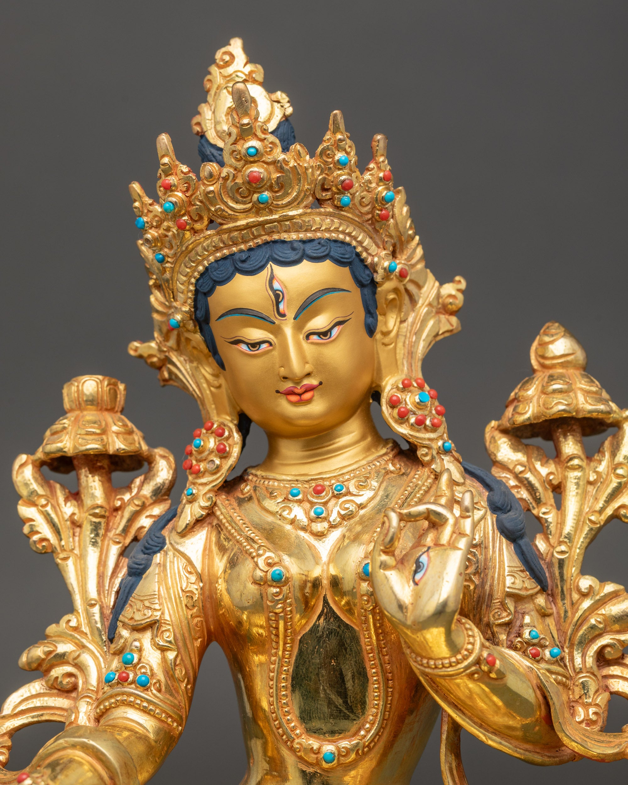 White Tara statue close up showing detailed hand gestures and robes