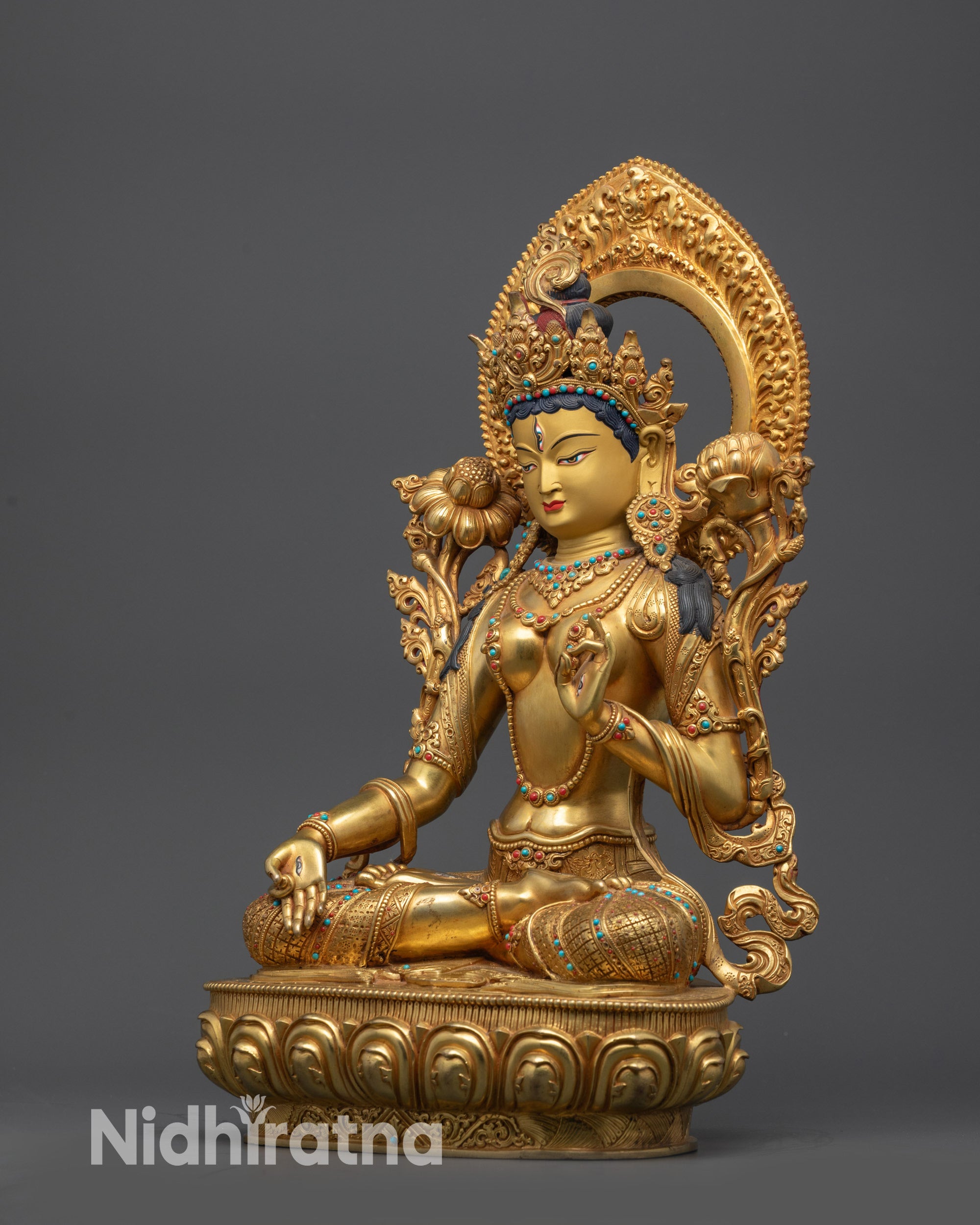 White Tara statue left side view showing intricate jewelry and carved patterns