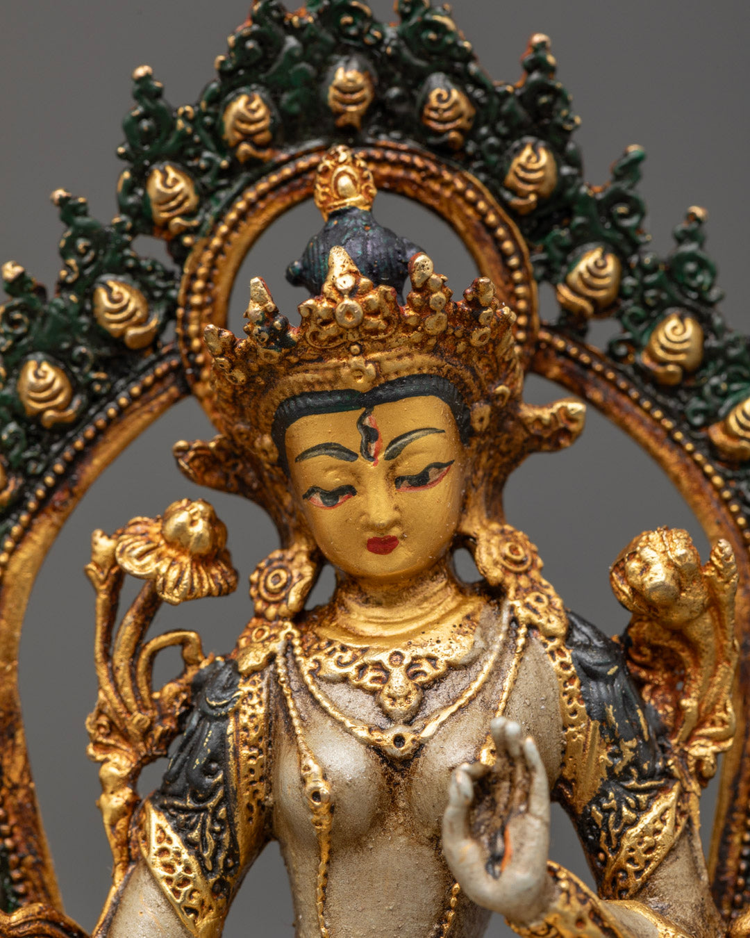 White Tara statue’s seven all-seeing eyes symbolizing spiritual awareness and compassion