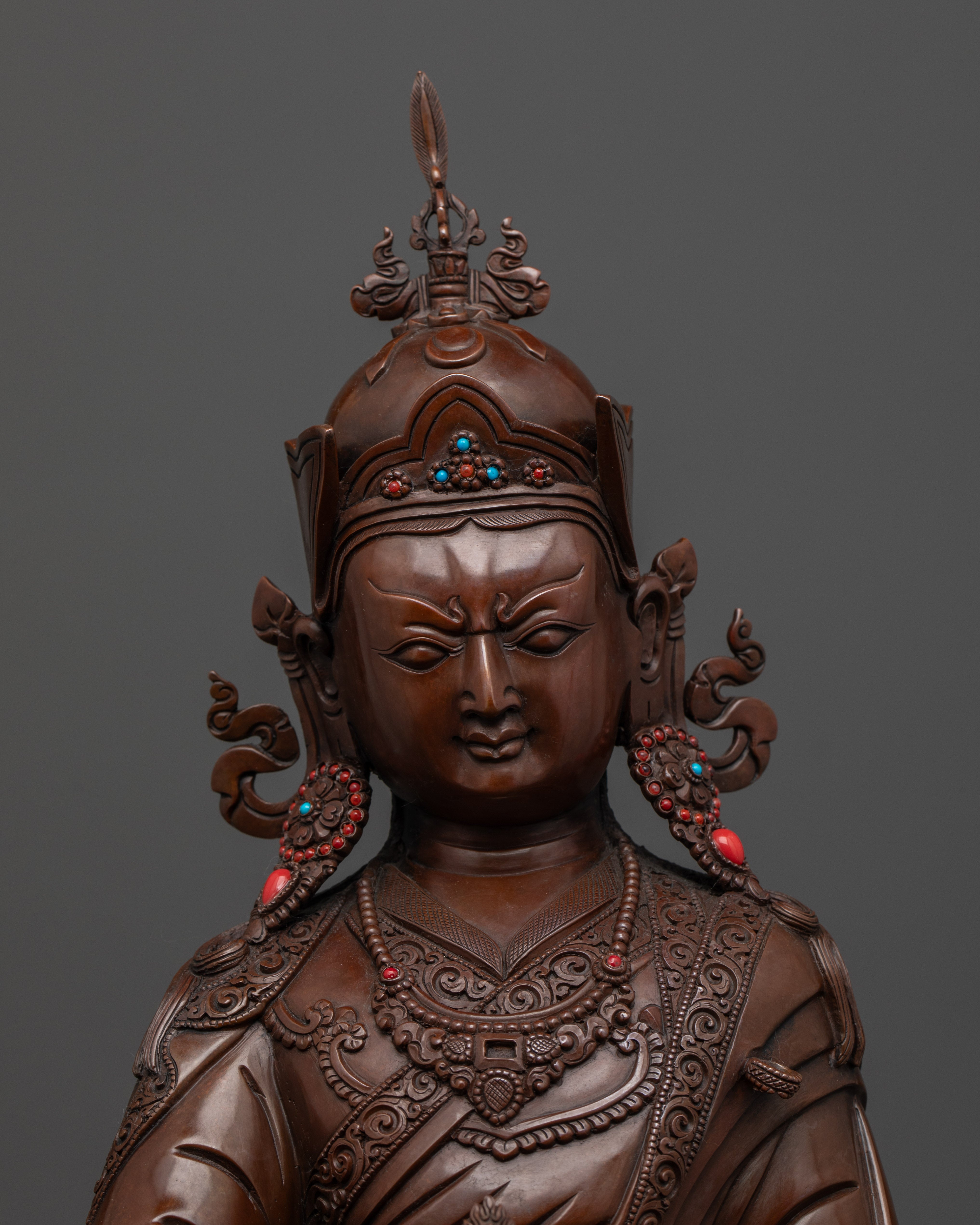 Zoom View of Padmasambhava statue adorned with semi-precious stones and antique finish