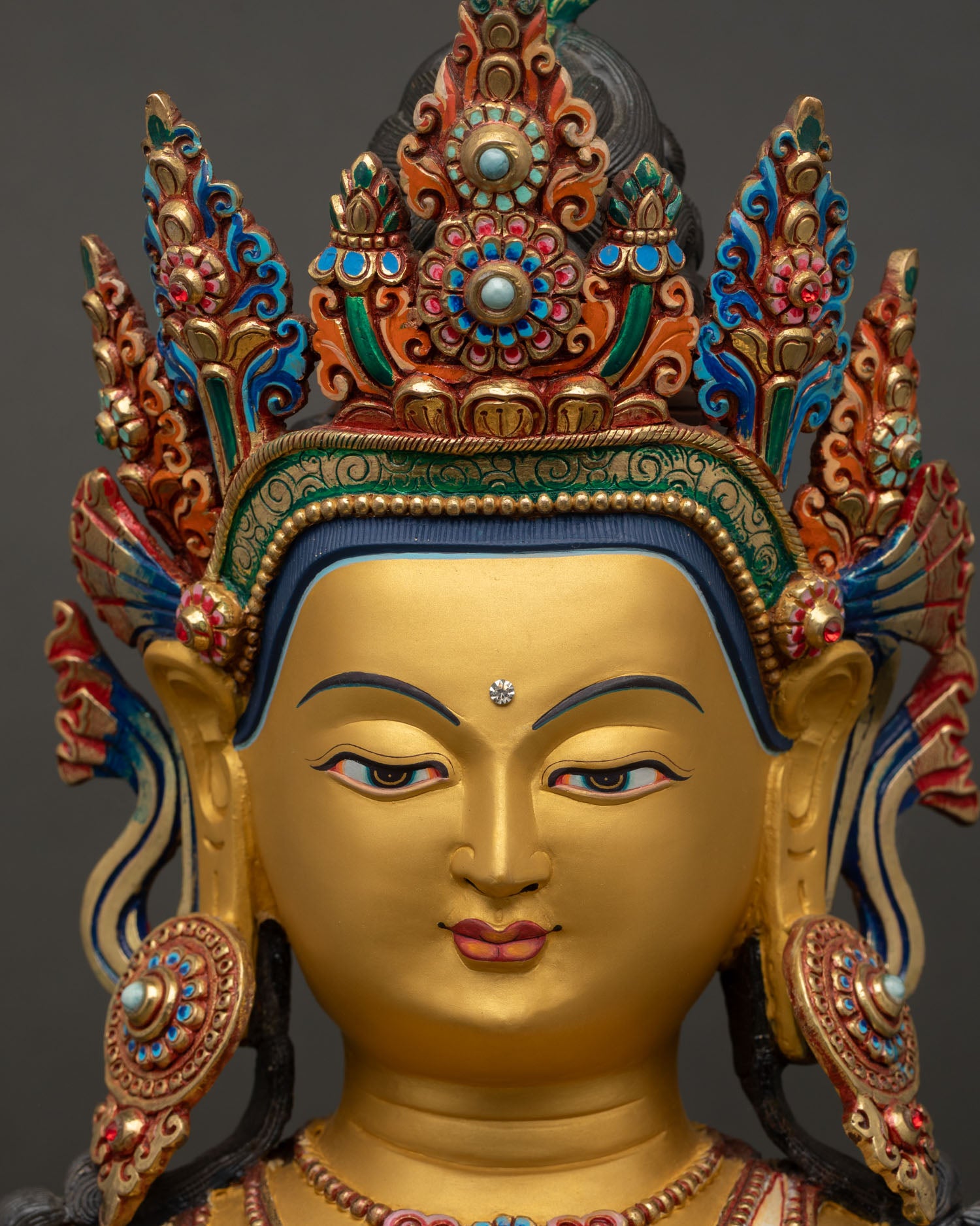 akshobhya buddha face close up gold painted serene expression nepal statue