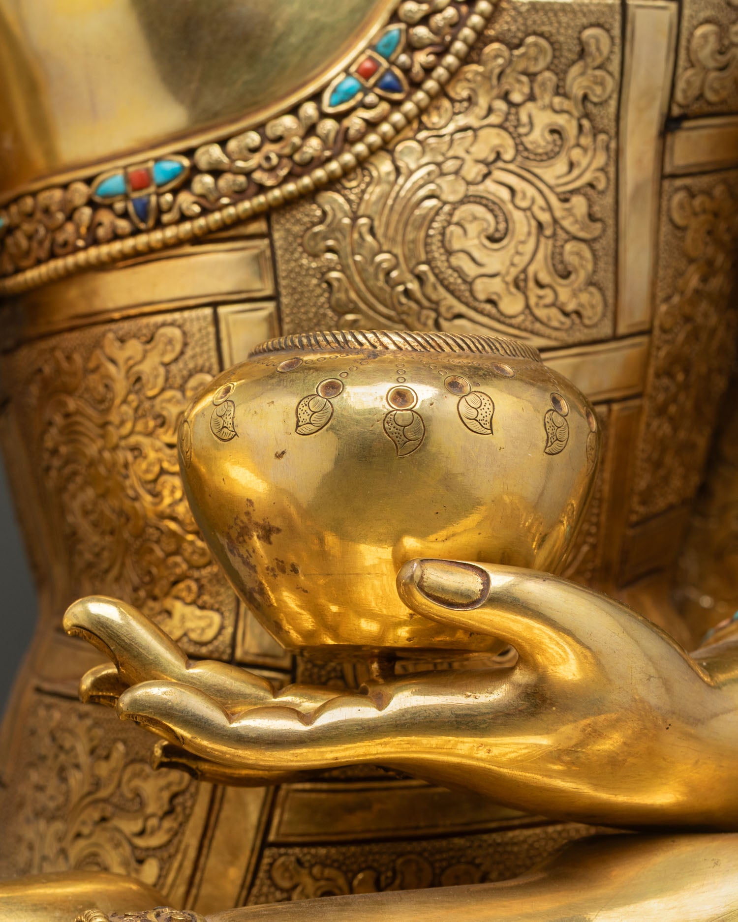 alms bowl detail held by shakyamuni buddha symbolizing renunciation and wisdom