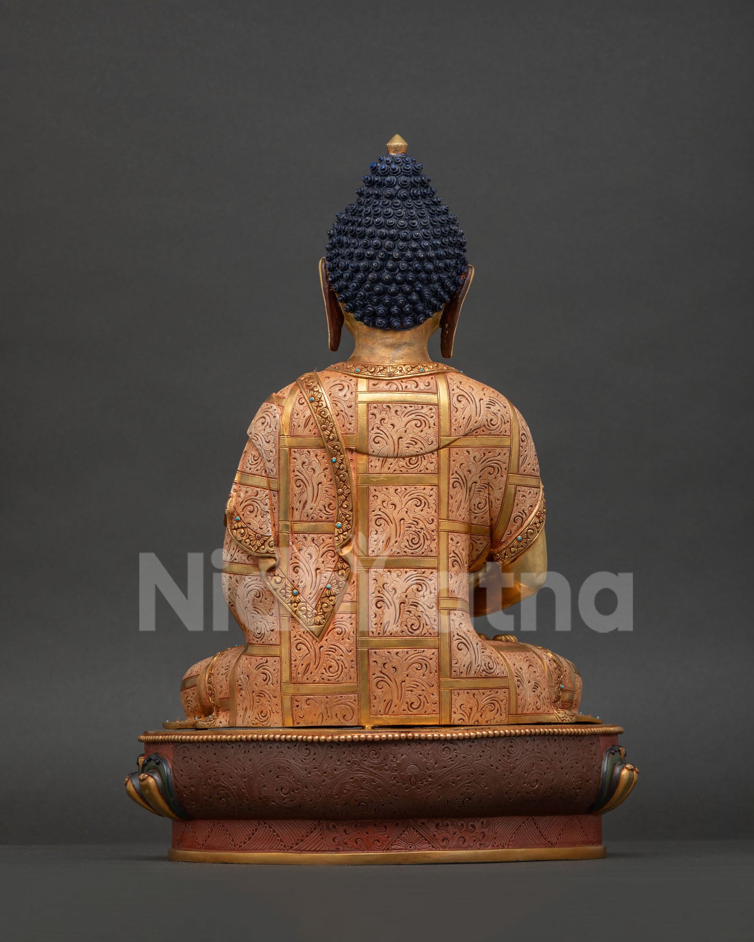 Amitabha Buddha back view, fire-gilded copper statue showing ornate robe details and decorative lotus base