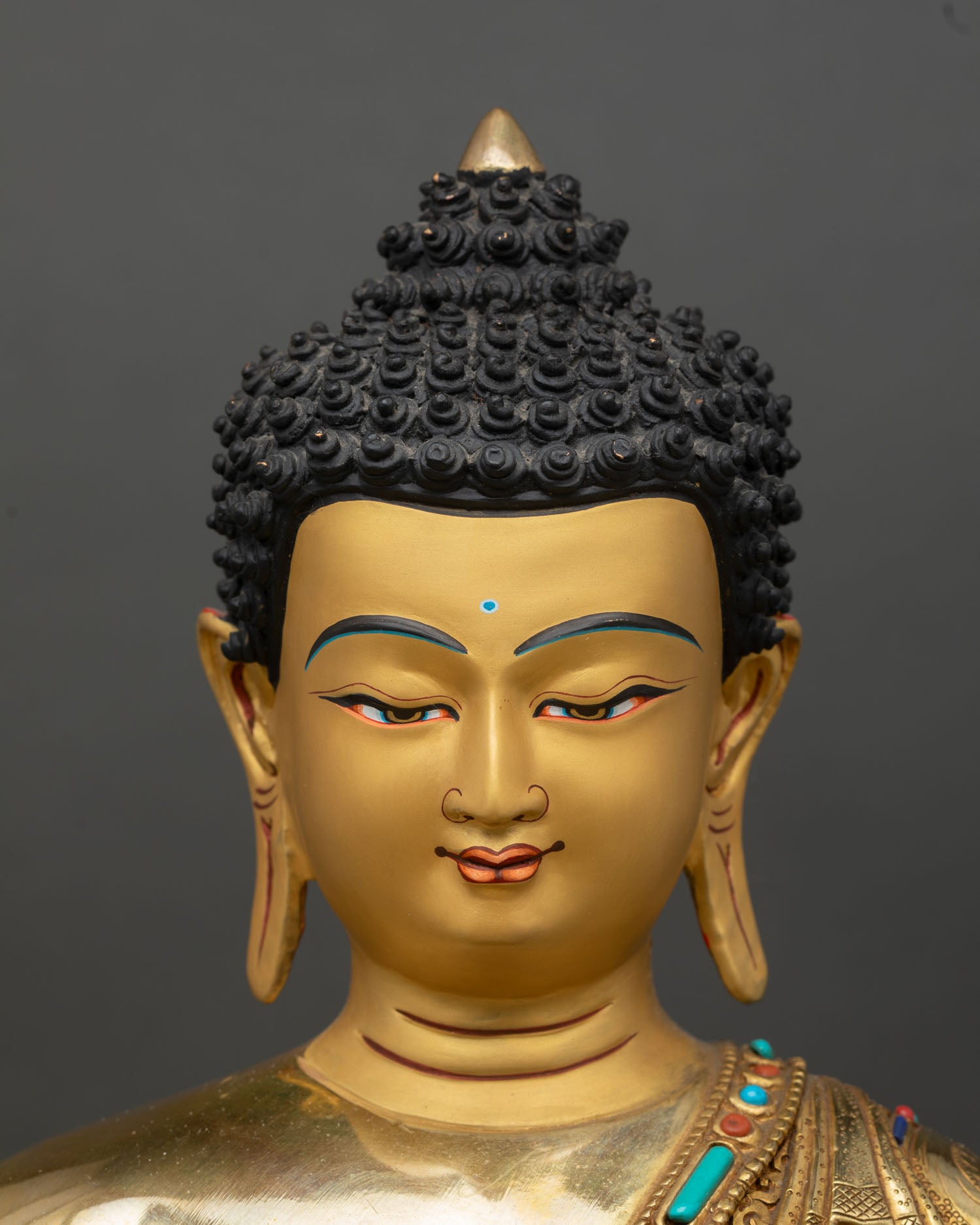 amitabha buddha face close up, serene expression gold painted buddhist statue nepal