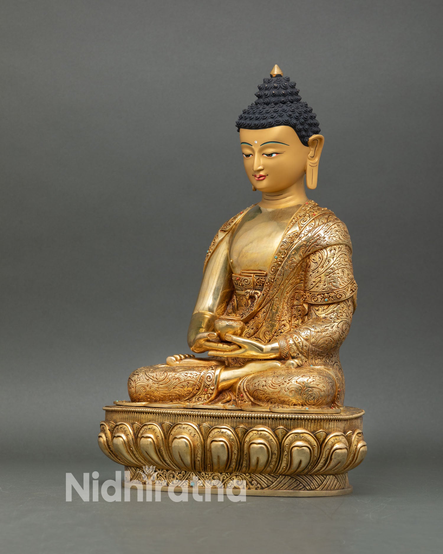 Amitabha Buddha in Dhyana mudra holding alms bowl detailed robe engraving floral scroll patterns Nepalese sculpture