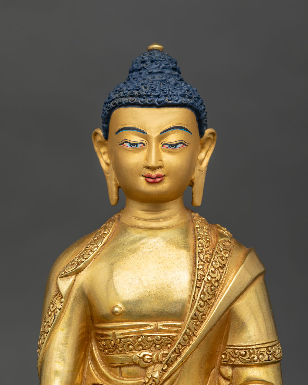 Amitabha Buddha statue 24K gold painted face Newari artistry Patan Nepal.
